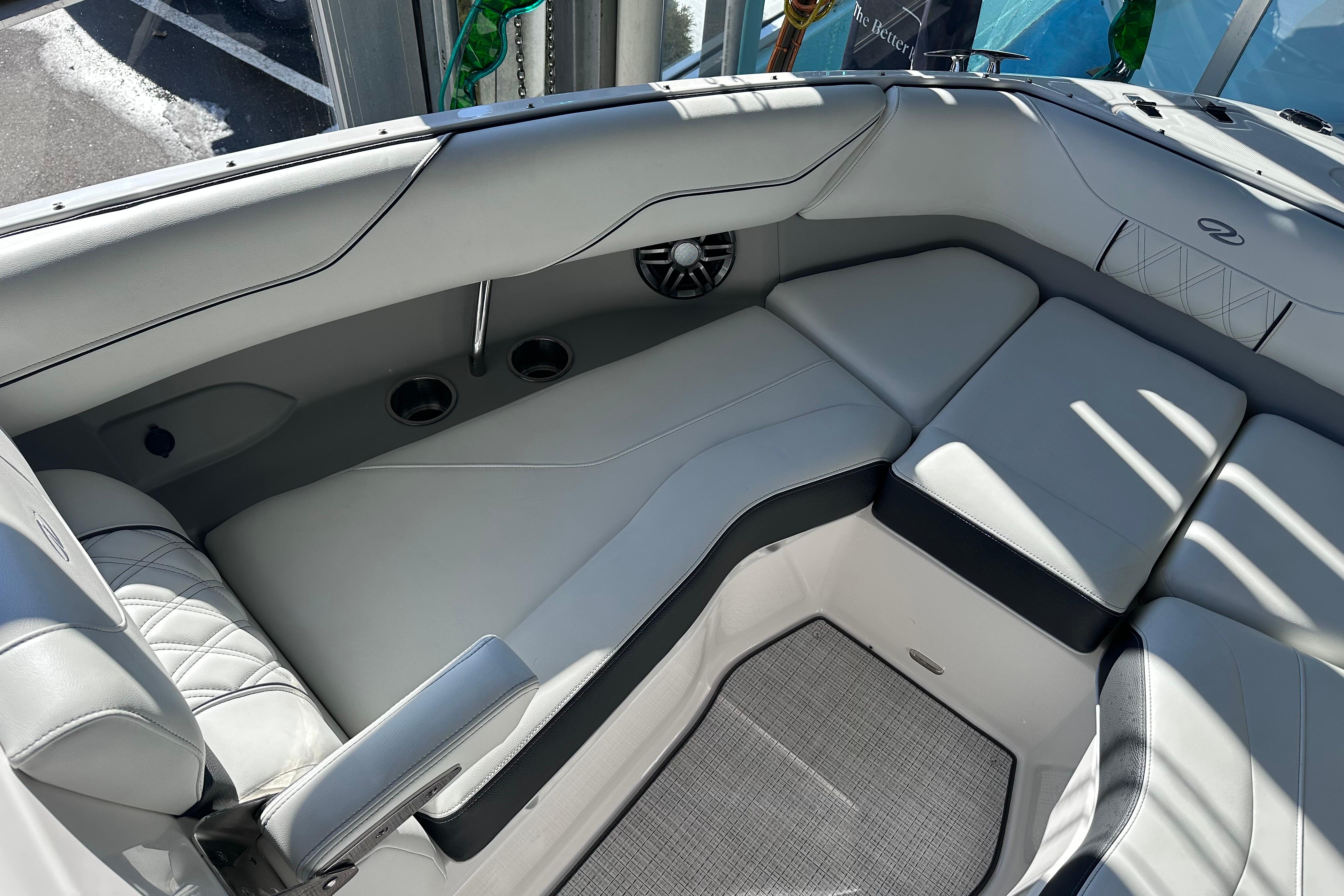 Luxurious interior of 2026 Regal LX4 boat with plush seating and cup holders.