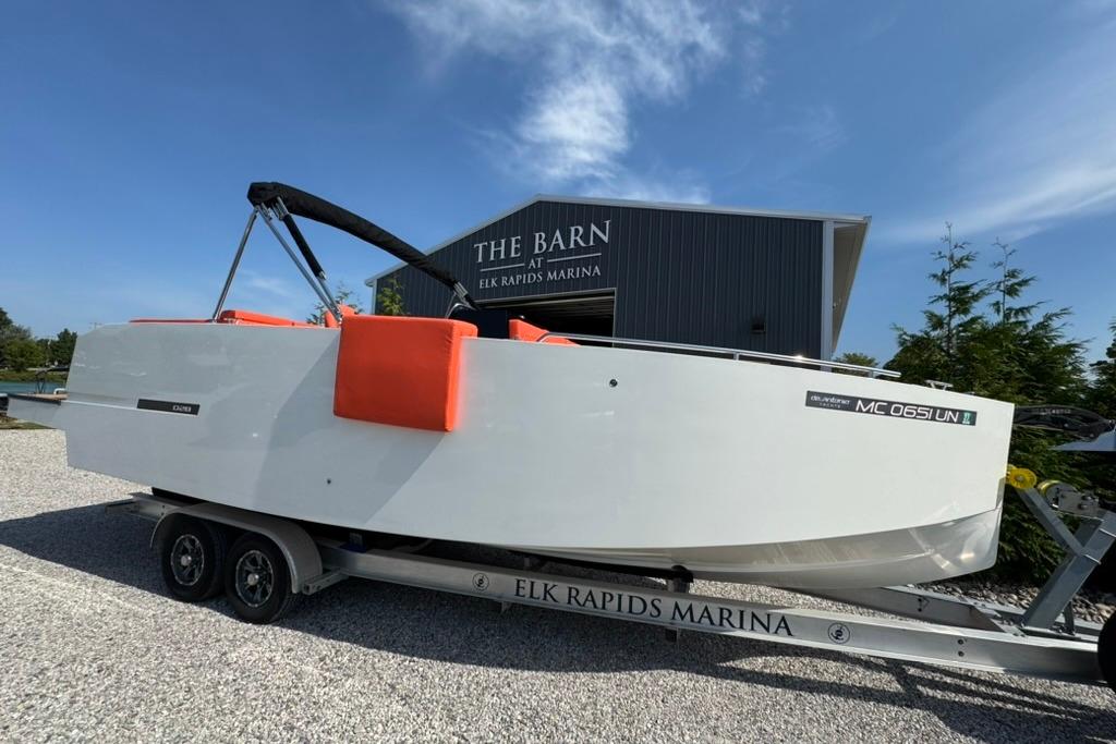 2020 De Antonio Yachts D28 on trailer at Elk Rapids Marina, clear sky background.