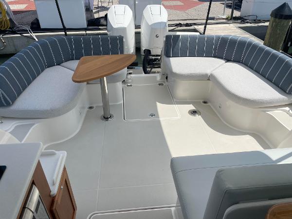 Back Cove 34O 2024 model boat with spacious seating and twin outboard engines.