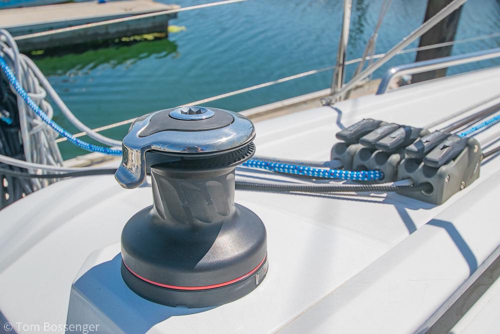 Winch and ropes on 2022 Beneteau Oceanis 30.1 sailboat deck, dockside view.