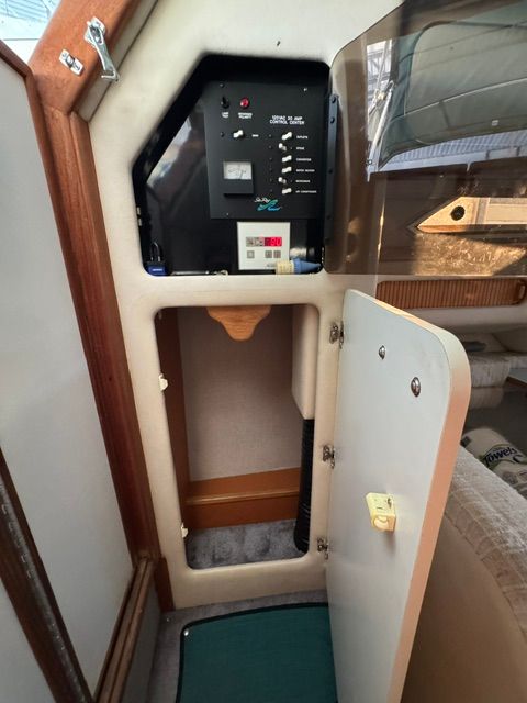 Interior of the 1992 Sea Ray 290 Sundancer featuring a control panel and storage space.