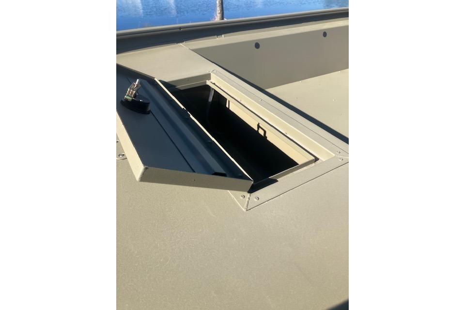 2026 Tracker Grizzly 1754 Utility boat with open storage compartment on deck.