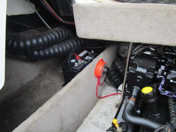 Engine compartment of a 2004 Ebbtide 22 Mystique boat, showing battery and wiring.