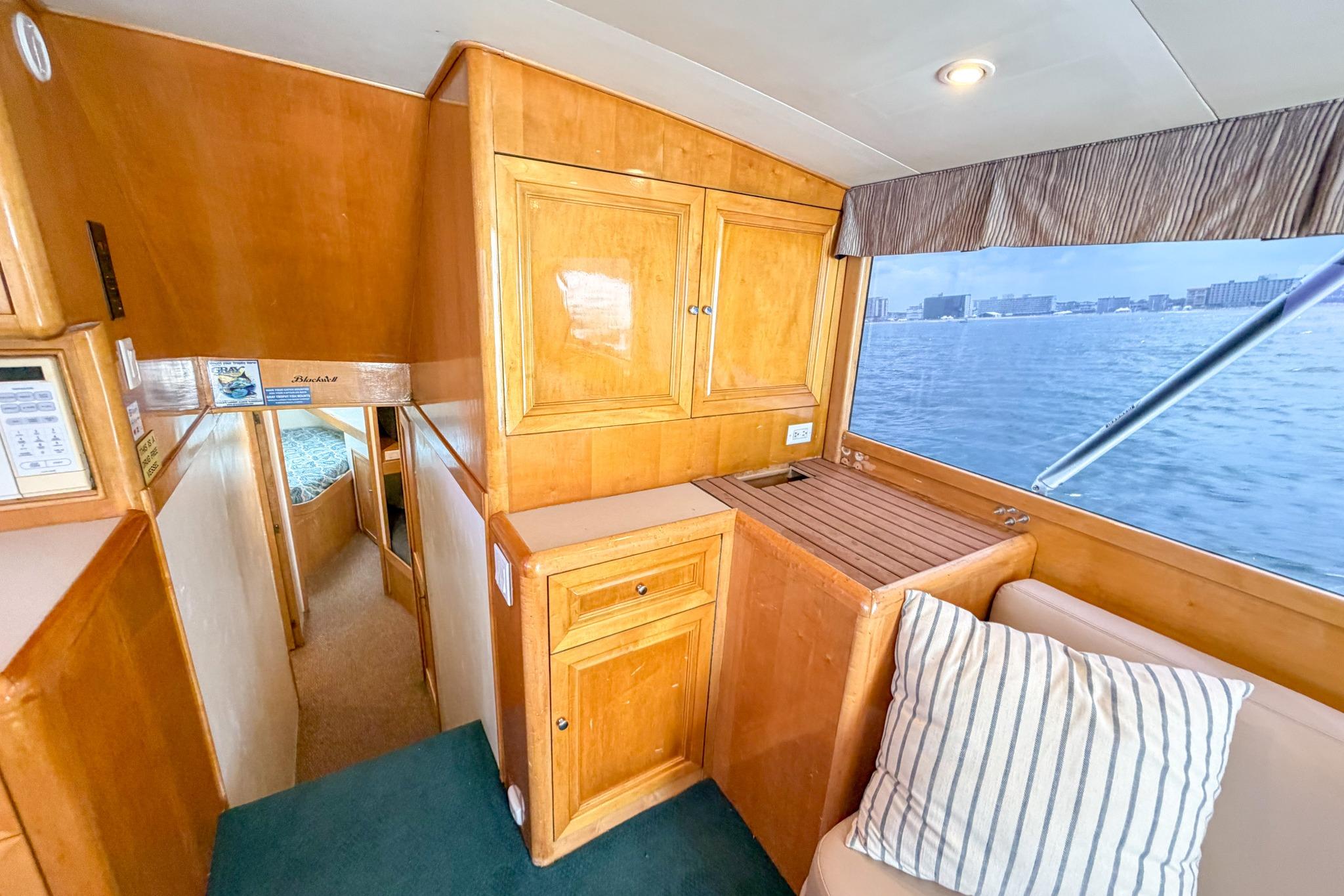 Interior of 1998 Blackwell Custom Carolina Sportfish with wood cabinetry and ocean view.