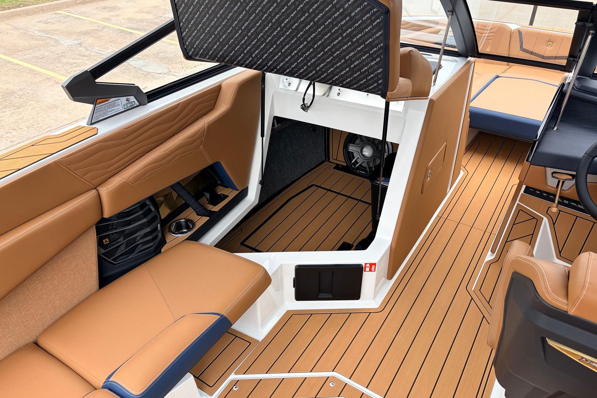 2026 Nautique Super Air Nautique G25 interior with tan seating and wood-style flooring.