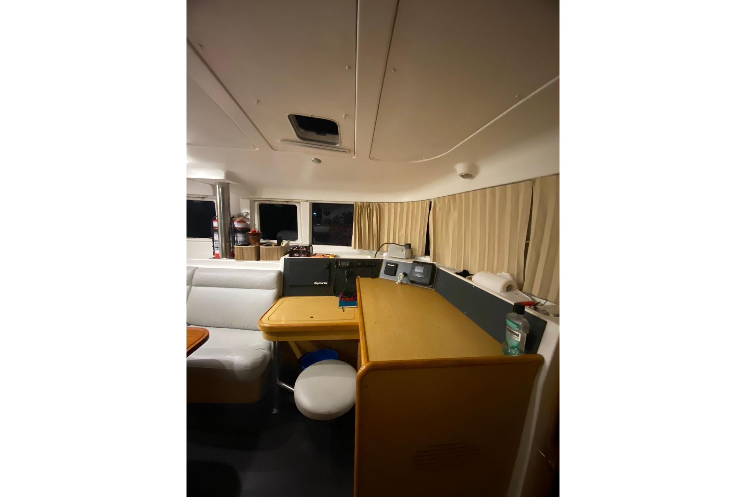 Interior of 2008 Lagoon 440 catamaran with navigation station and seating area.