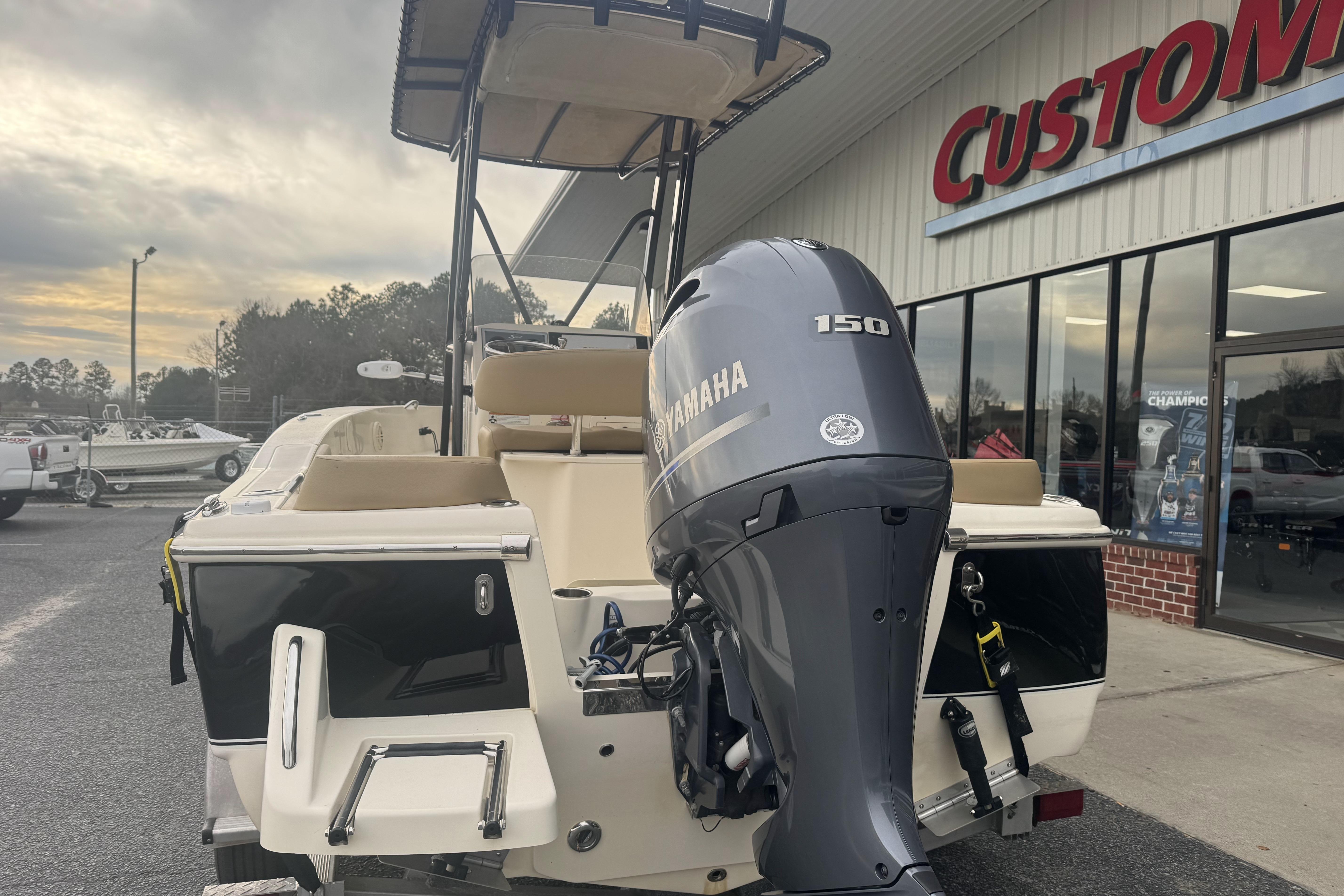 2020 Scout 195 Sportfish boat with Yamaha 150 engine outside dealership.