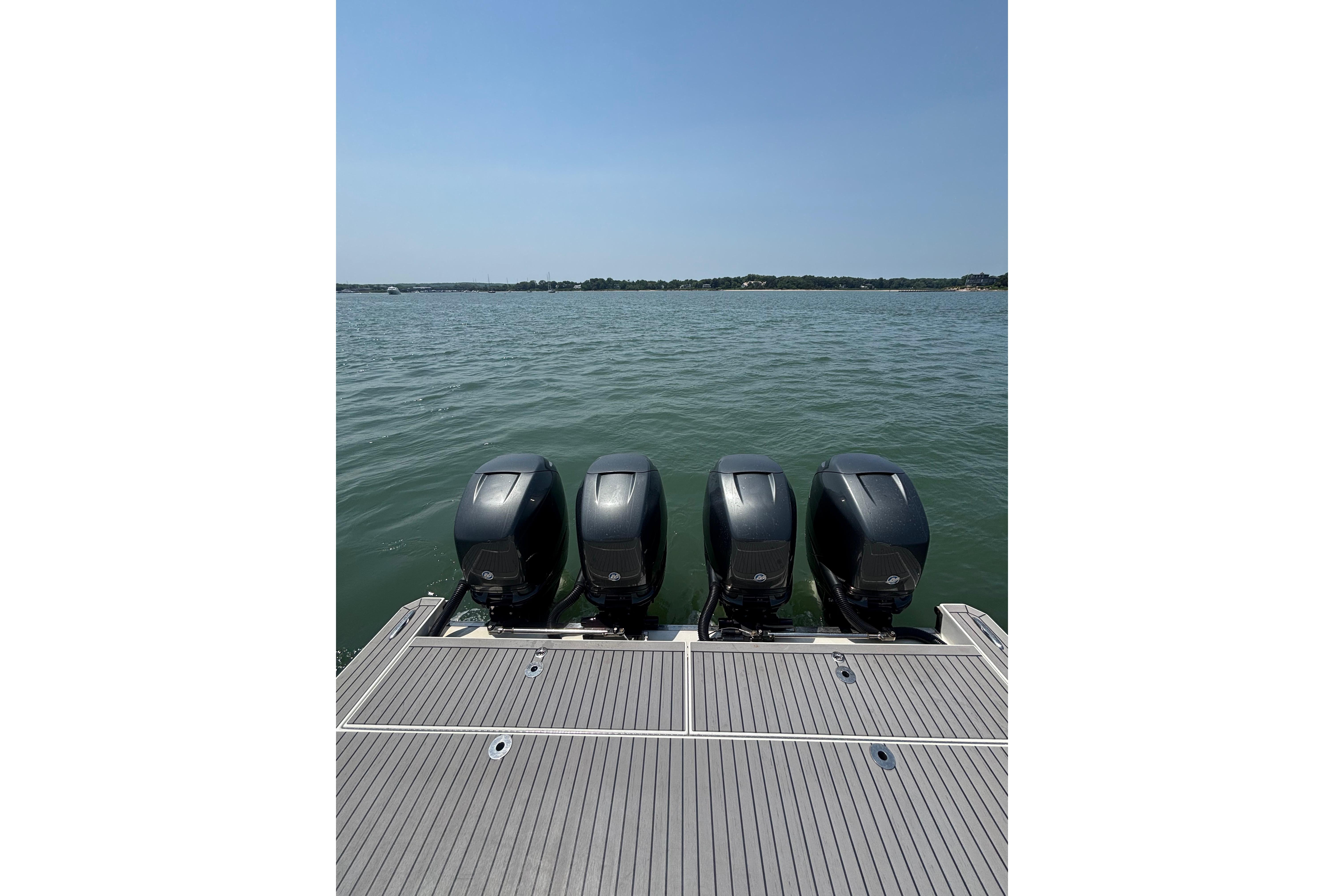 2019 Formula 430 Super Sport Crossover with four powerful outboard engines on a calm lake.