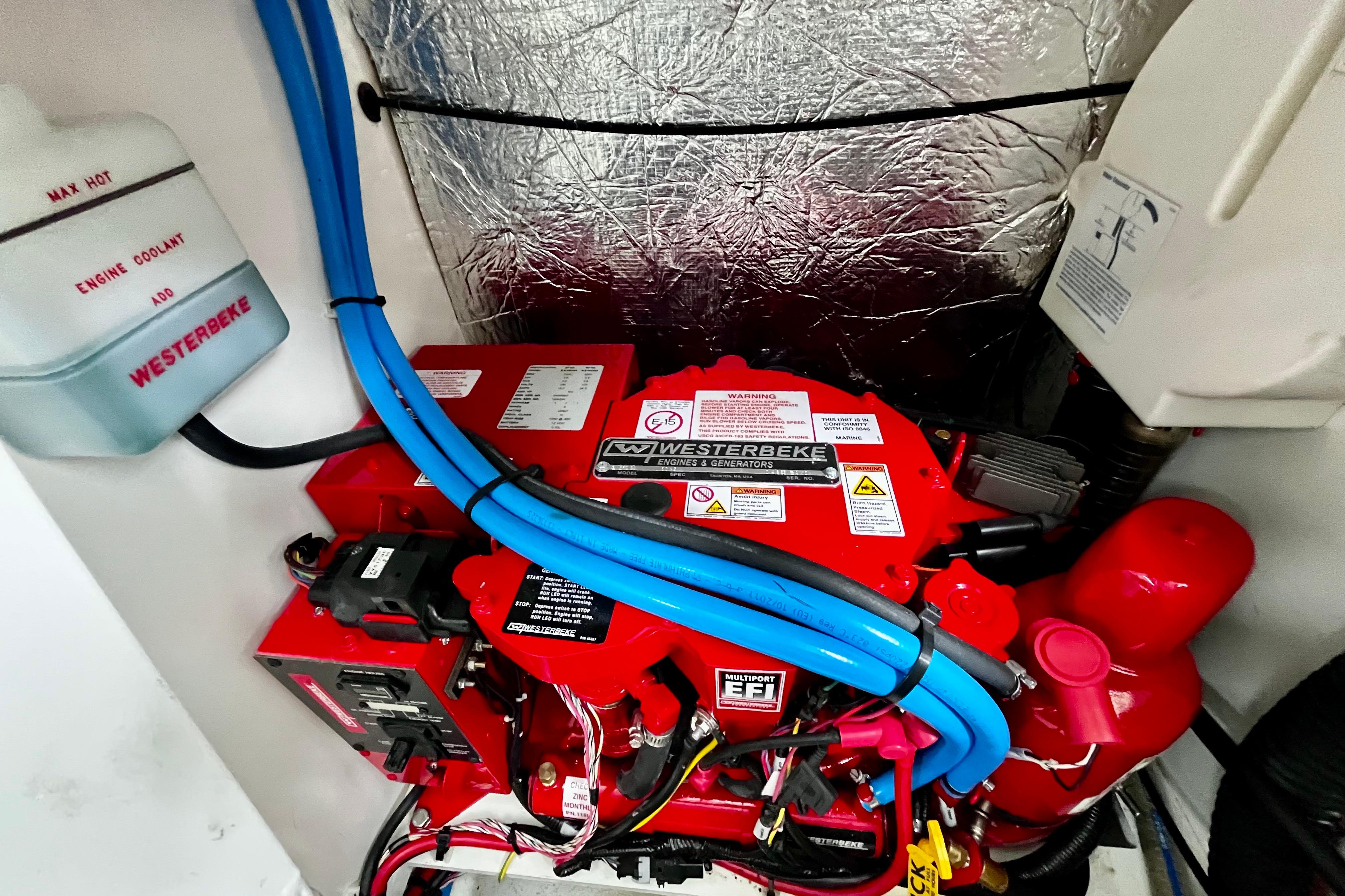 Engine compartment of 2023 Beneteau Gran Turismo 32 with Westerbeke generator.