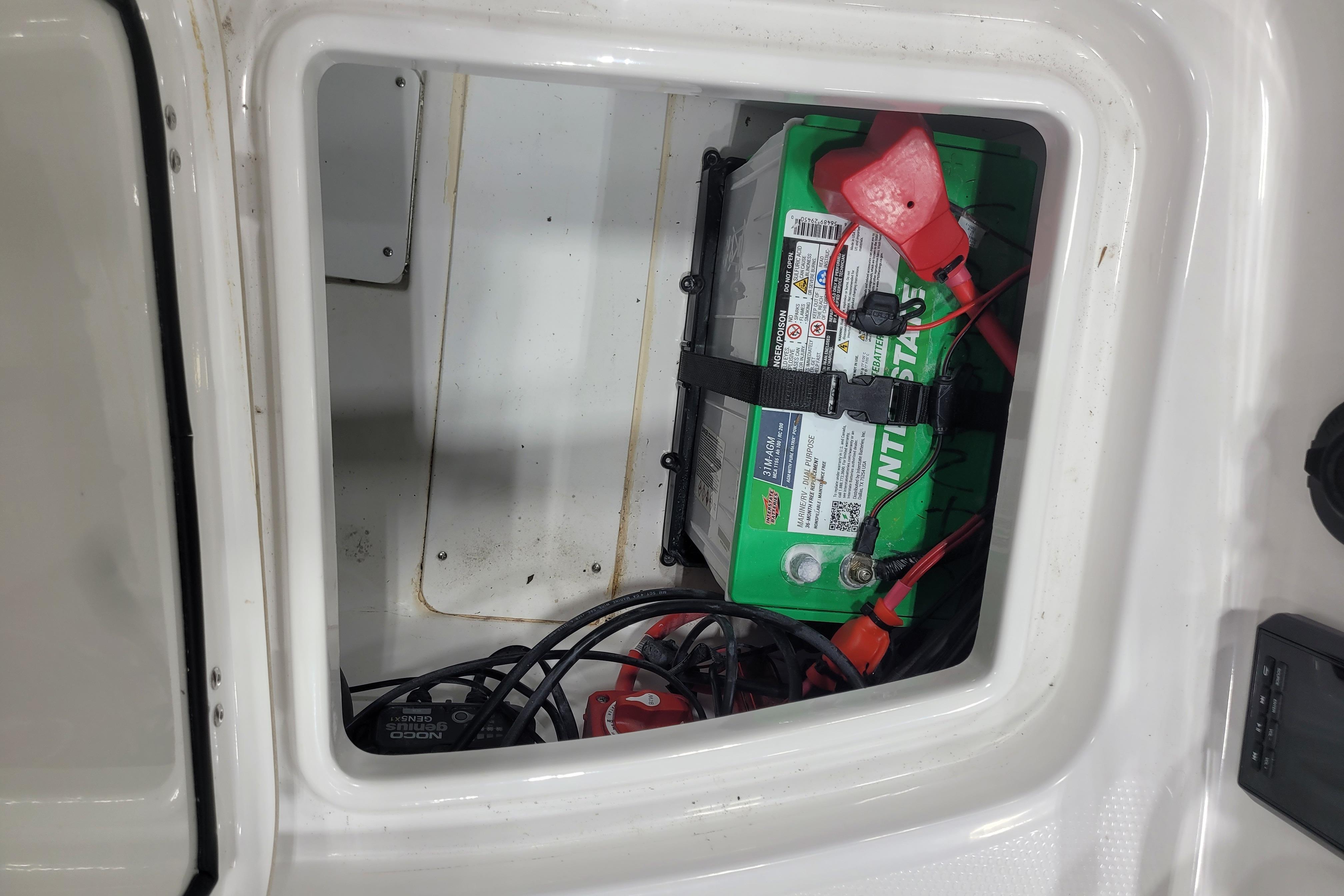 Battery compartment of a 2026 Tahoe 2150 boat with visible wiring and connections.