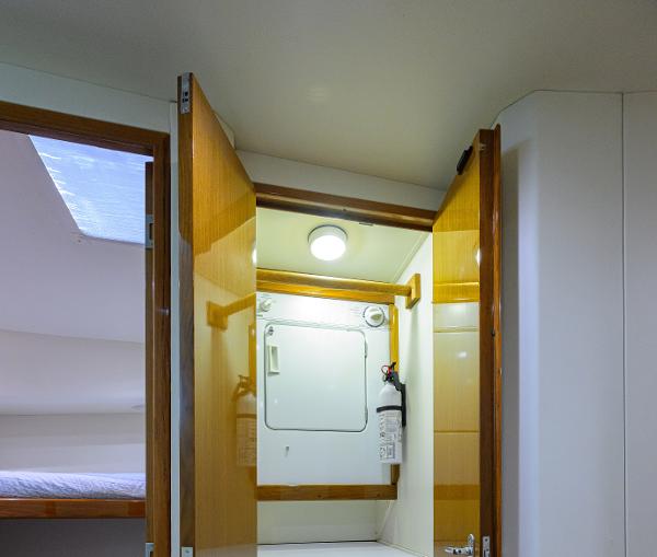 Interior of 2000 Viking 50 Convertible yacht, featuring wooden doors and a cozy cabin space.