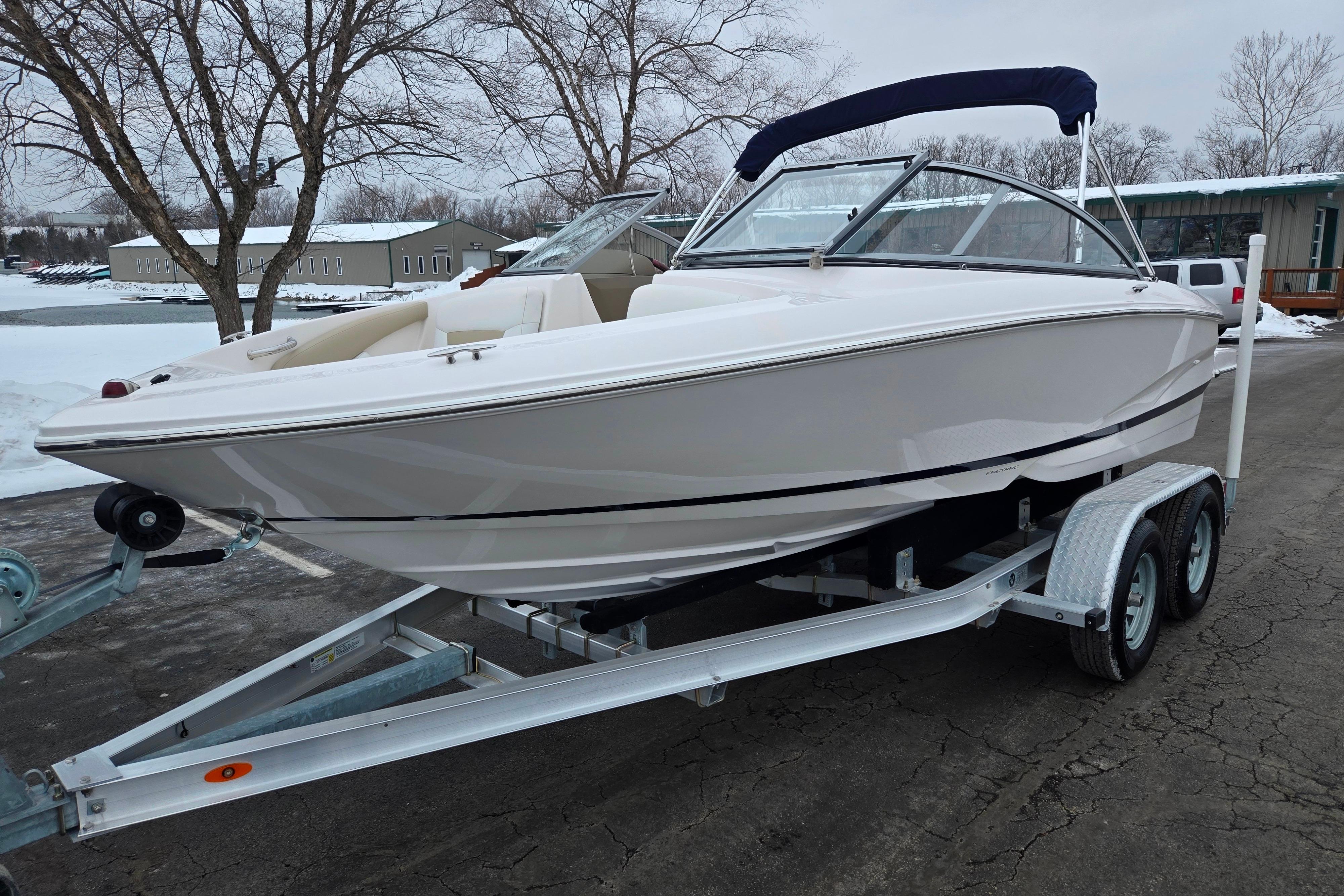 2015 Regal 1900 ES Bowrider on trailer, parked in snowy outdoor setting.
