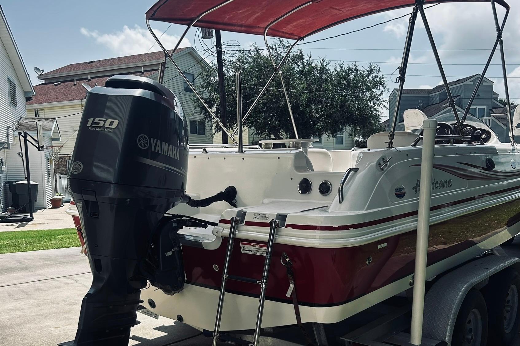 2013 Hurricane SunDeck Sport 201 OB boat with Yamaha 150 engine on trailer.
