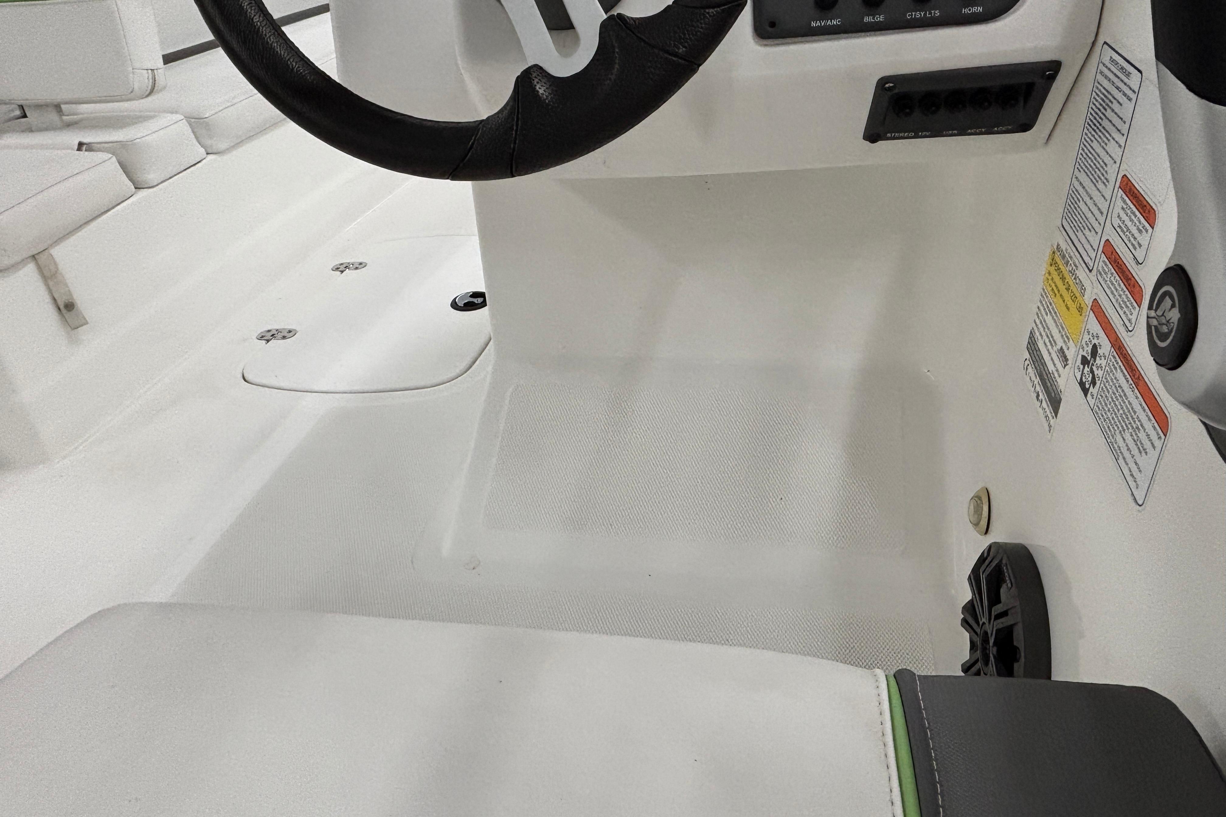 2024 Tahoe T18 boat interior with steering wheel and control panel details.