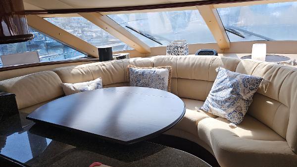 Luxurious interior of 2005 Neptunus 56 Flybridge yacht with plush seating and elegant decor.