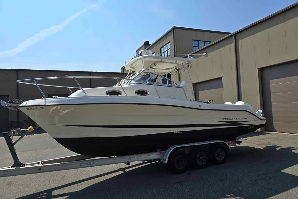 2003 Hydra-Sports Vector 2800 WA boat on trailer, parked outside industrial building.
