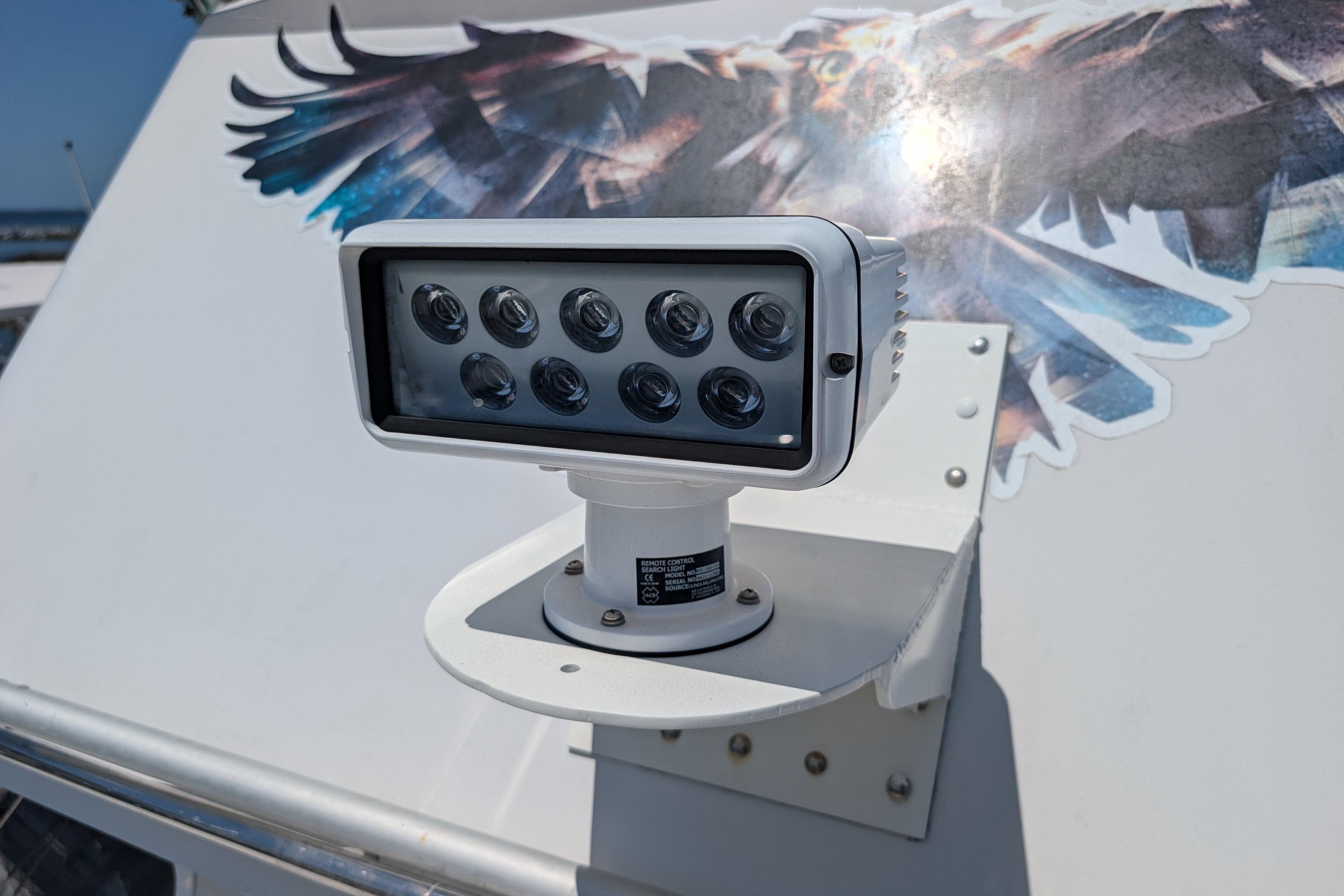 LED spotlight on 2004 PDQ 34 Powercat boat with eagle graphic background.