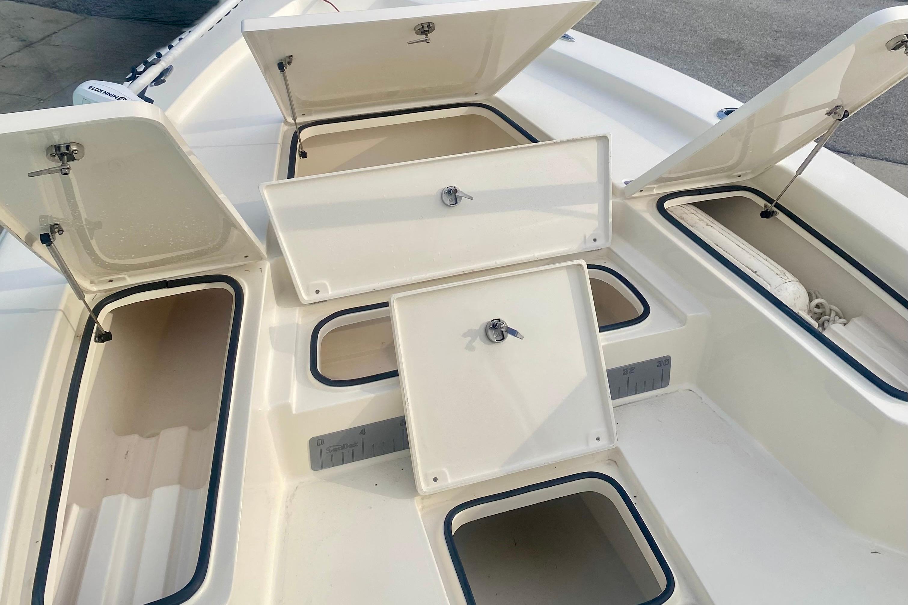 Open storage compartments on a 2018 Avenger AV24 boat deck.