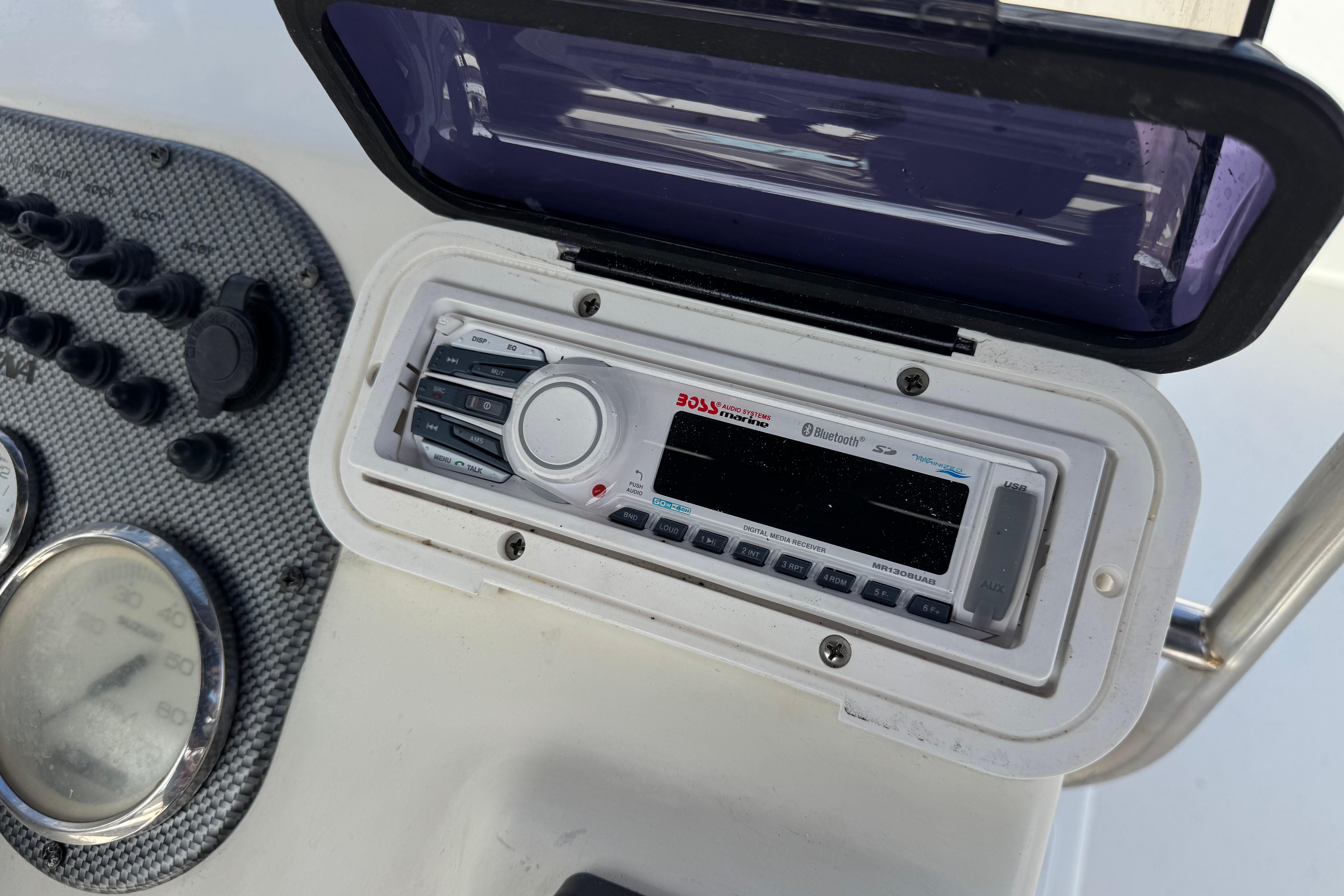 Boat dashboard featuring a Boss audio system on a 2013 Carolina Skiff Sea Chaser 1950 RG.