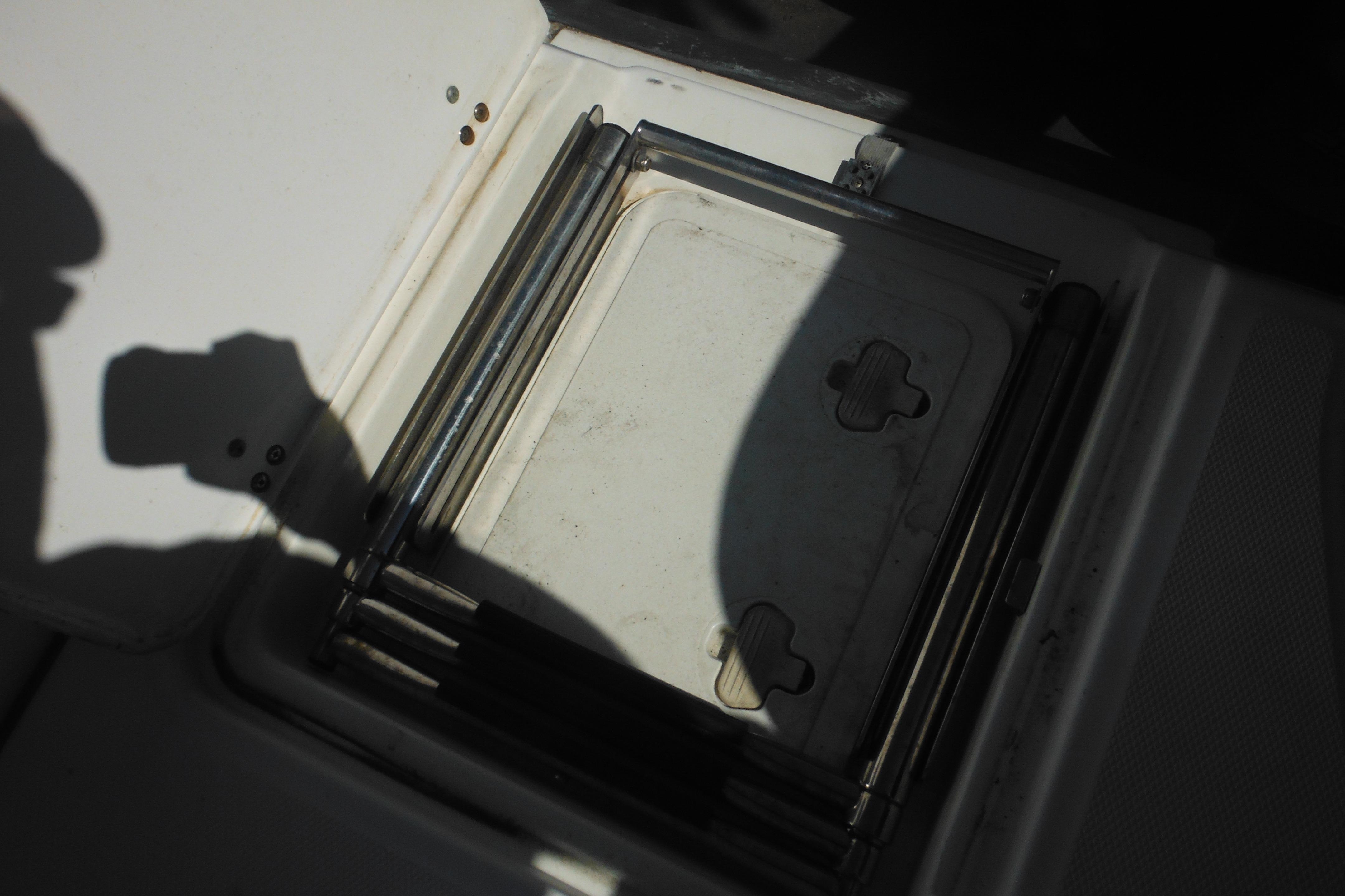 Open storage compartment on a 2009 Boston Whaler 200 Dauntless boat.