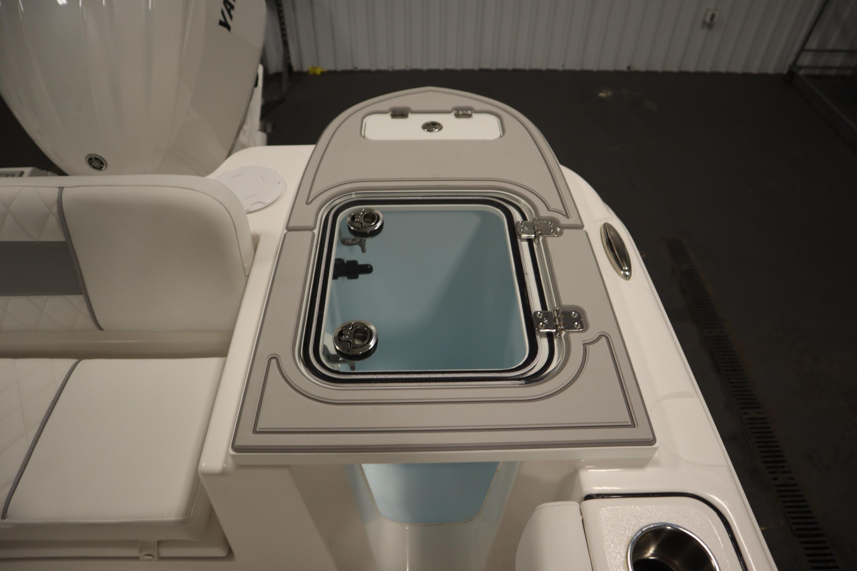 2026 Sea Fox 228 Commander boat with open storage compartment and seating area.