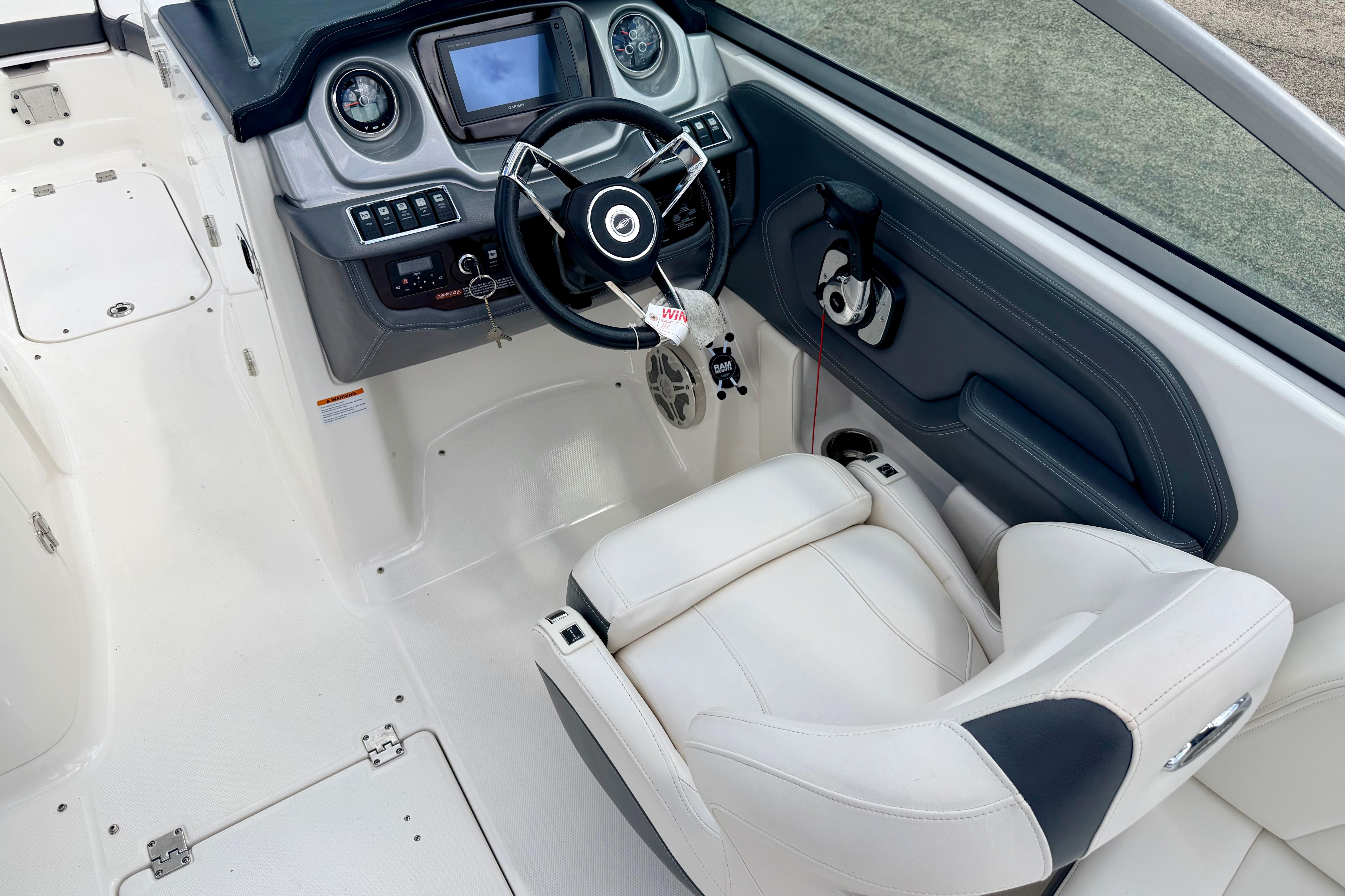 2015 Chaparral Sunesta 264 boat interior with steering wheel and dashboard controls.