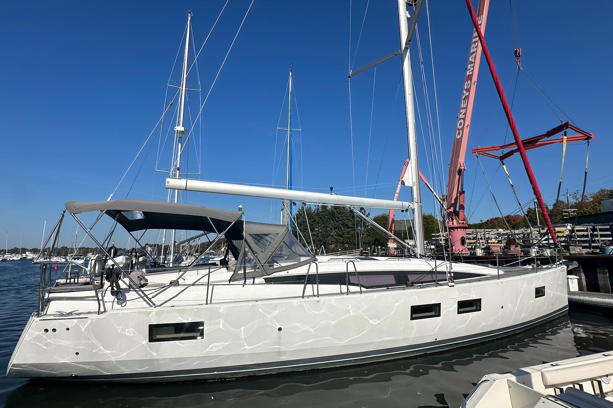 2018 Jeanneau 51 sailboat docked at marina under clear blue sky.