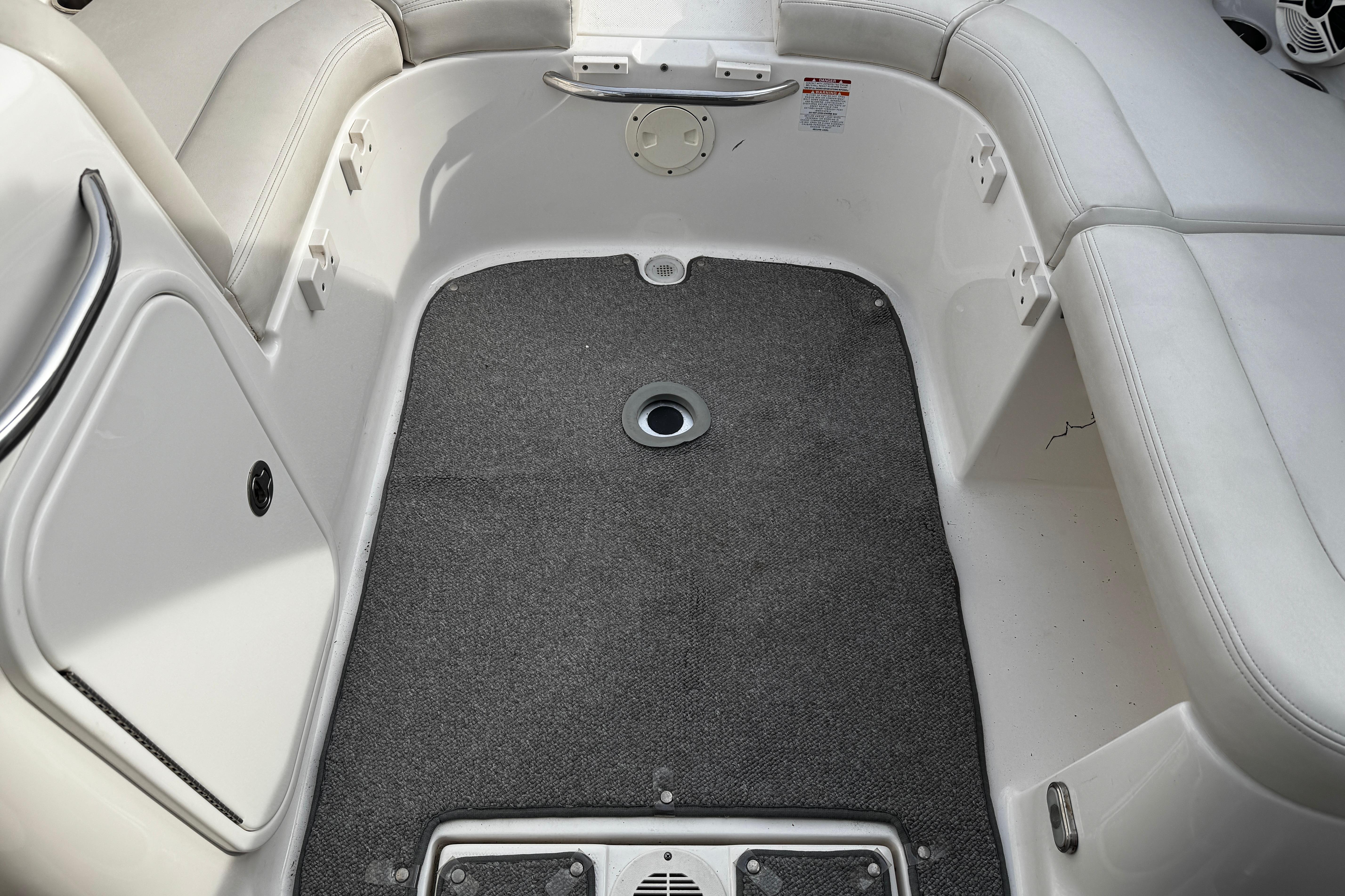 2008 Chaparral 256 SSi boat interior with gray carpet and white seating.