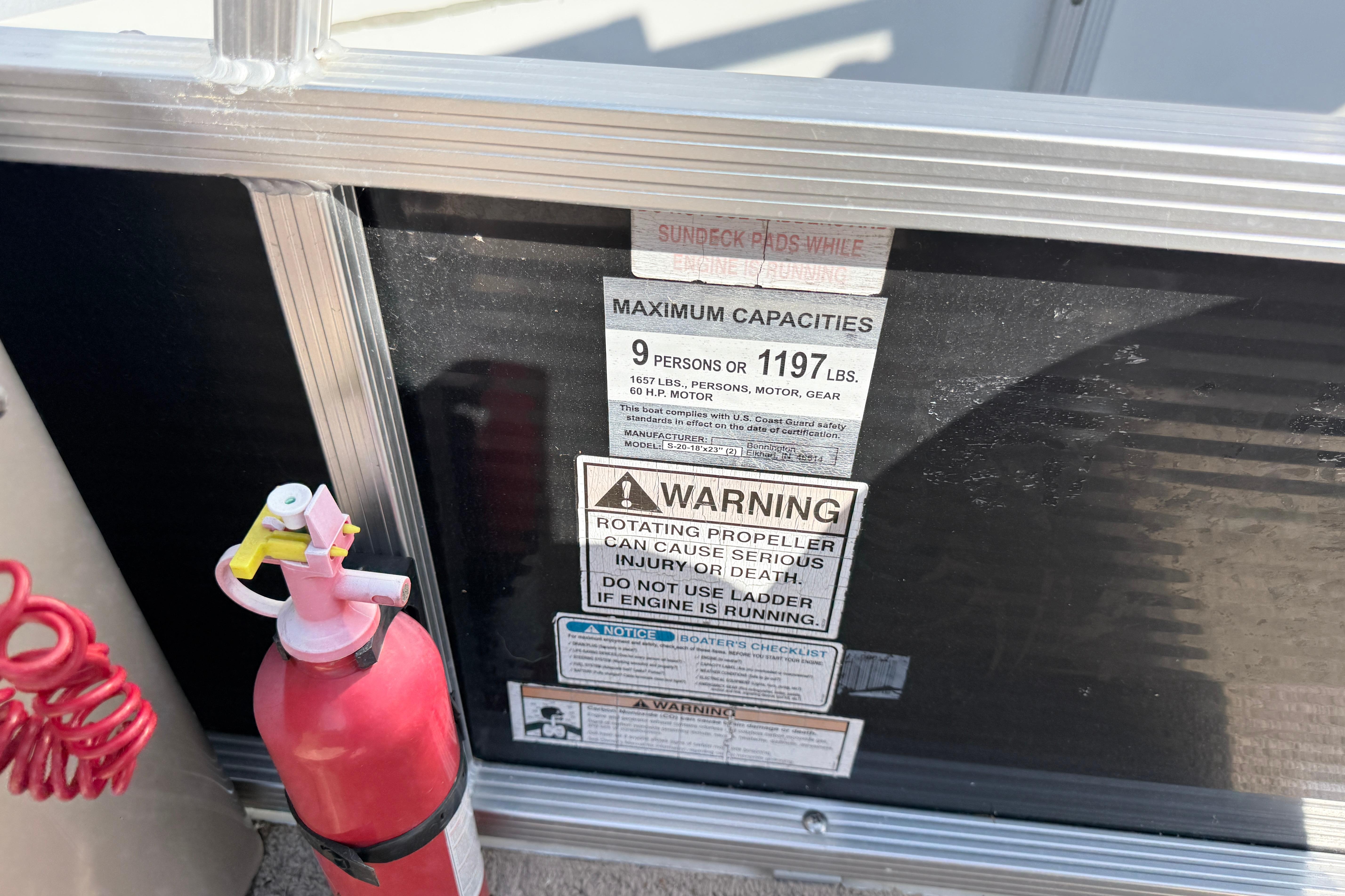 Fire extinguisher and safety warnings on 2010 Bennington 20SLi boat.
