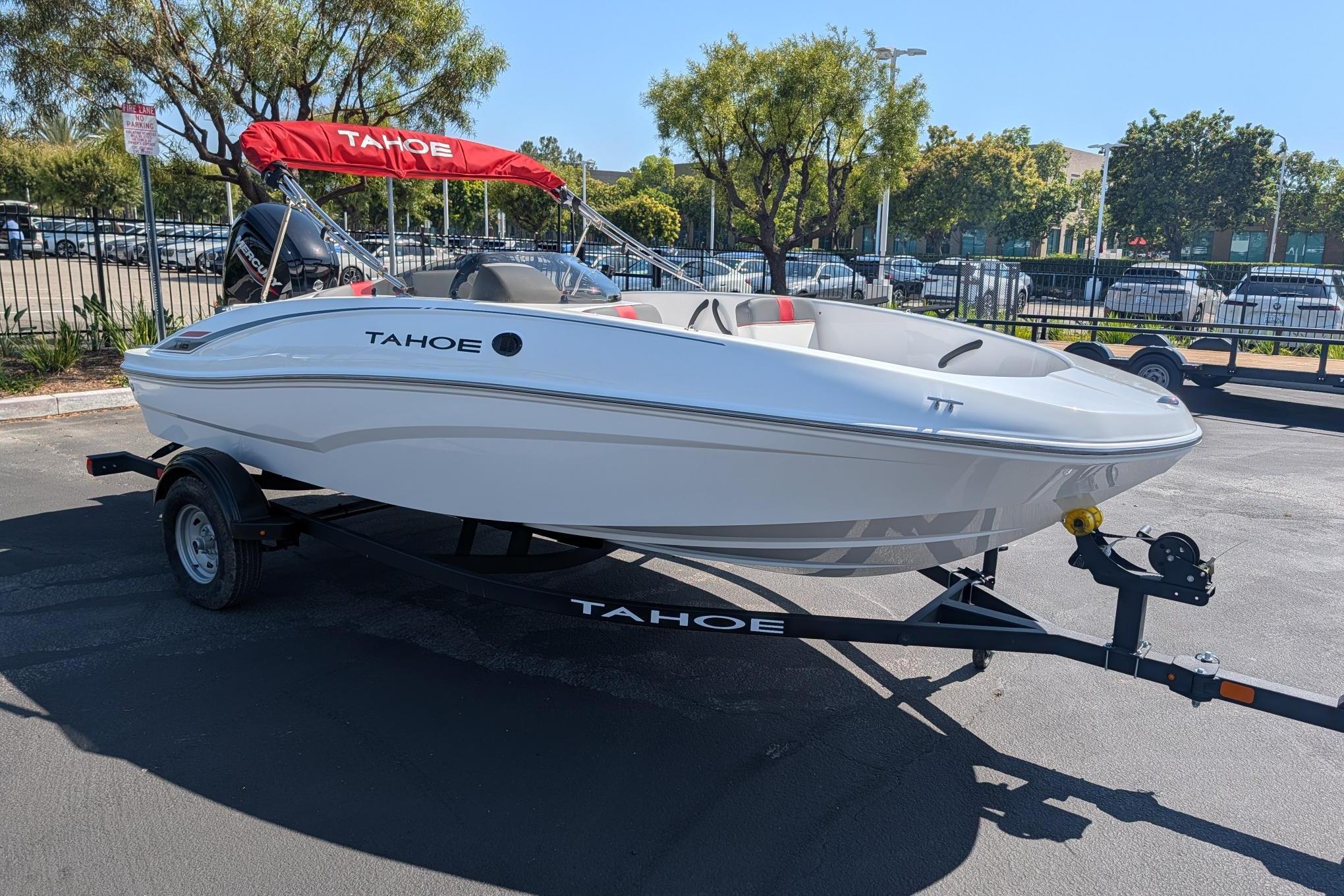 2026 Tahoe T16 boat on trailer with red canopy, parked outdoors.