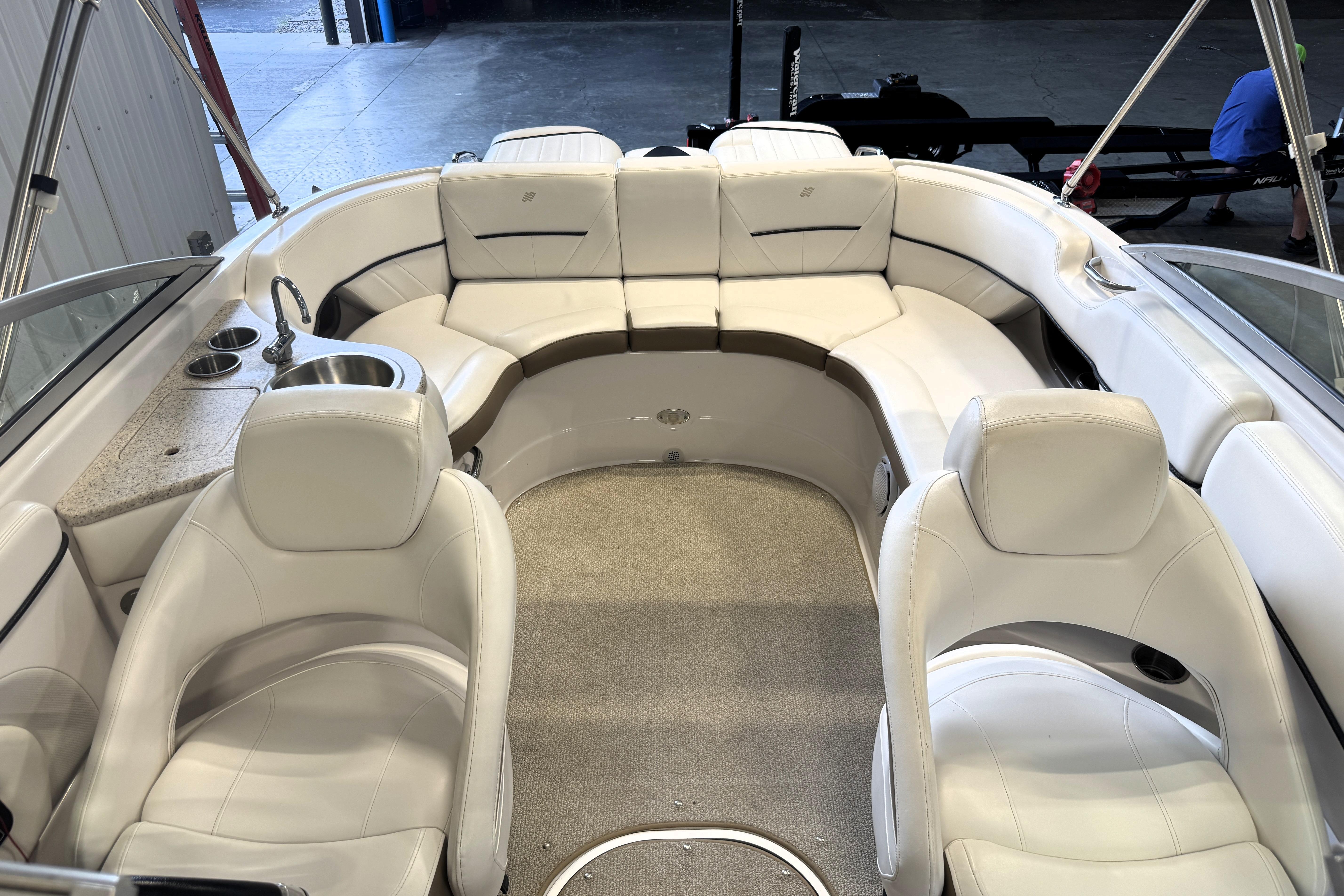 Luxurious interior of 2008 Four Winns H240 boat with white seating and built-in amenities.