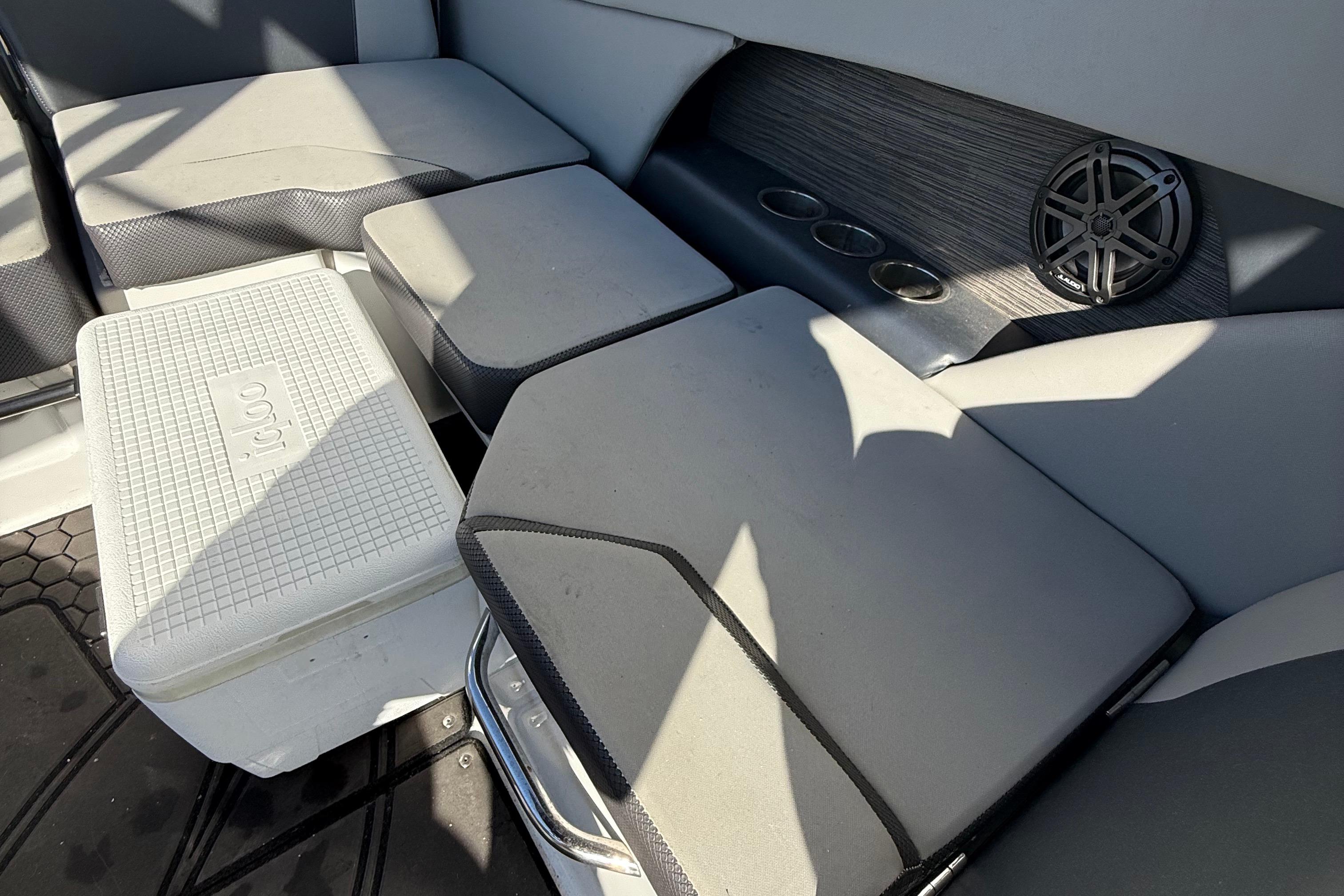 Interior of 2021 Scarab 255 ID boat with seating, cooler, and speaker.