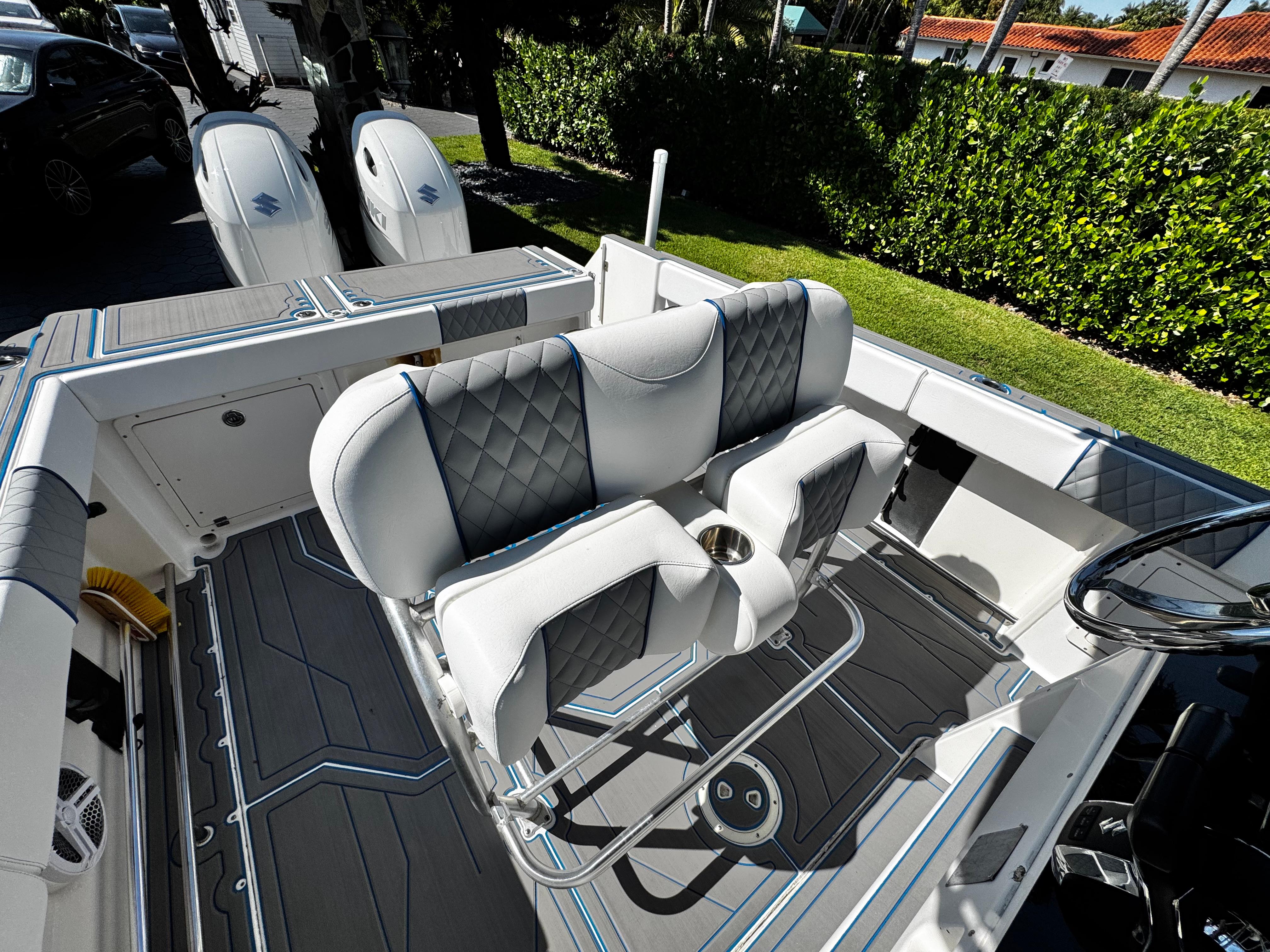 2004 Robalo R 260 boat interior with cushioned seating and dual outboard motors.
