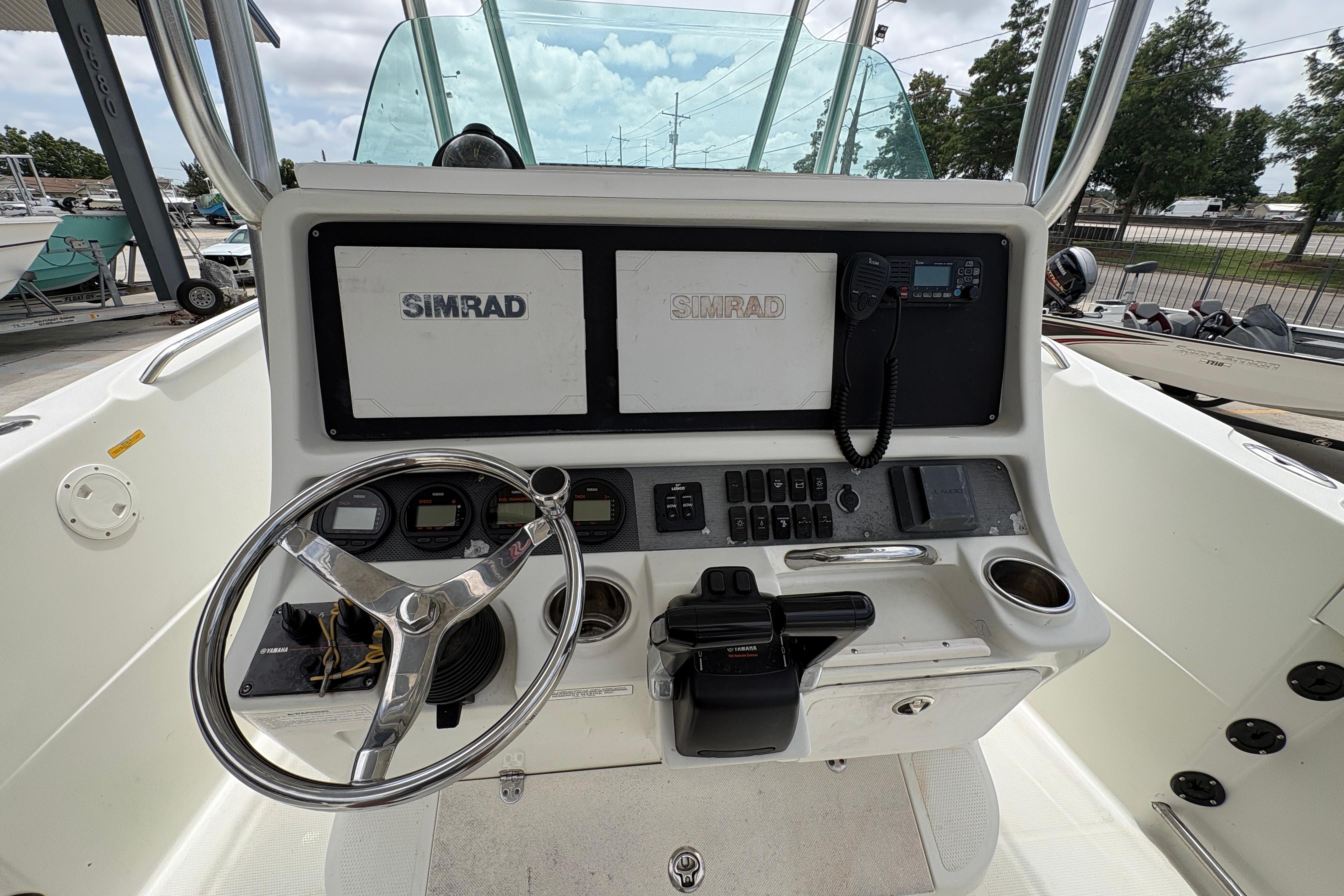 2006 Sail Faish 2360 boat dashboard with Simrad navigation system and steering wheel.