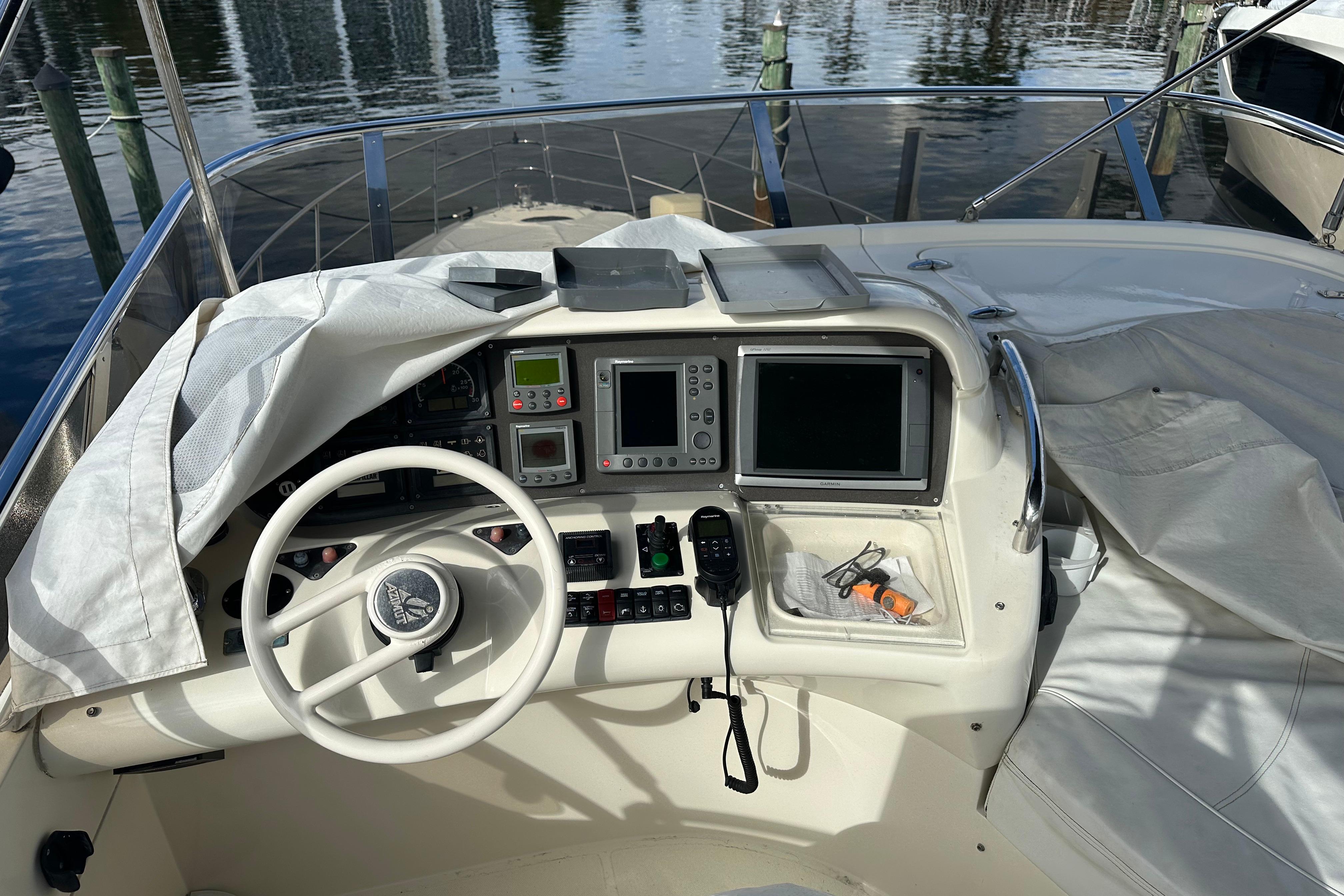 Cockpit of 2004 Azimut 55E yacht with steering wheel and navigation equipment.