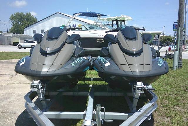Two 2023 Yamaha FX Cruiser HO jet skis on a trailer, parked outdoors.