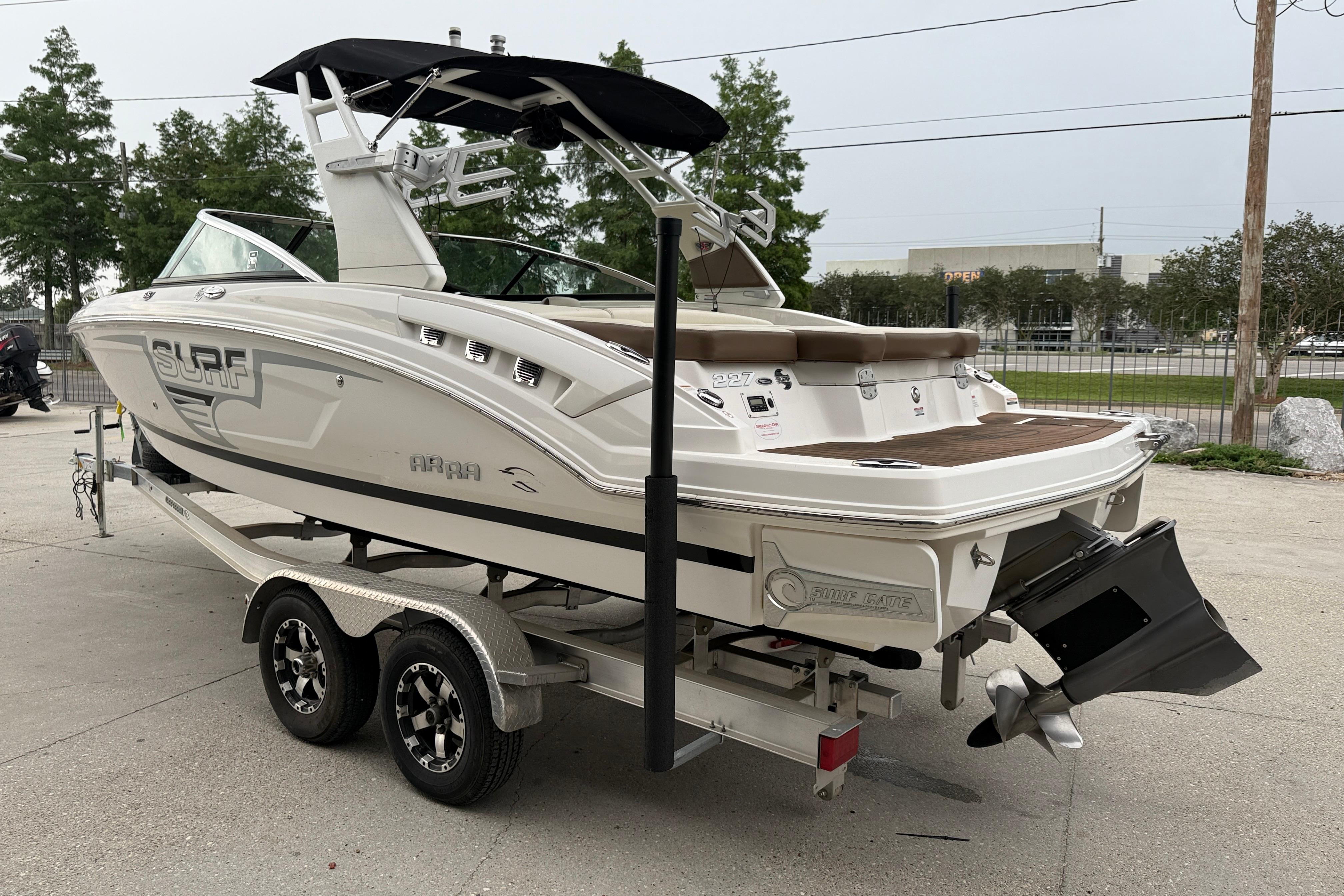 2018 Chaparral 227 SSX Surf boat on trailer, featuring sleek design and modern features.