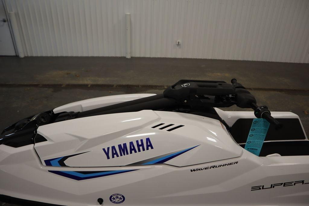 2025 Yamaha WaveRunner SuperJet in a showroom, showcasing sleek design and branding.