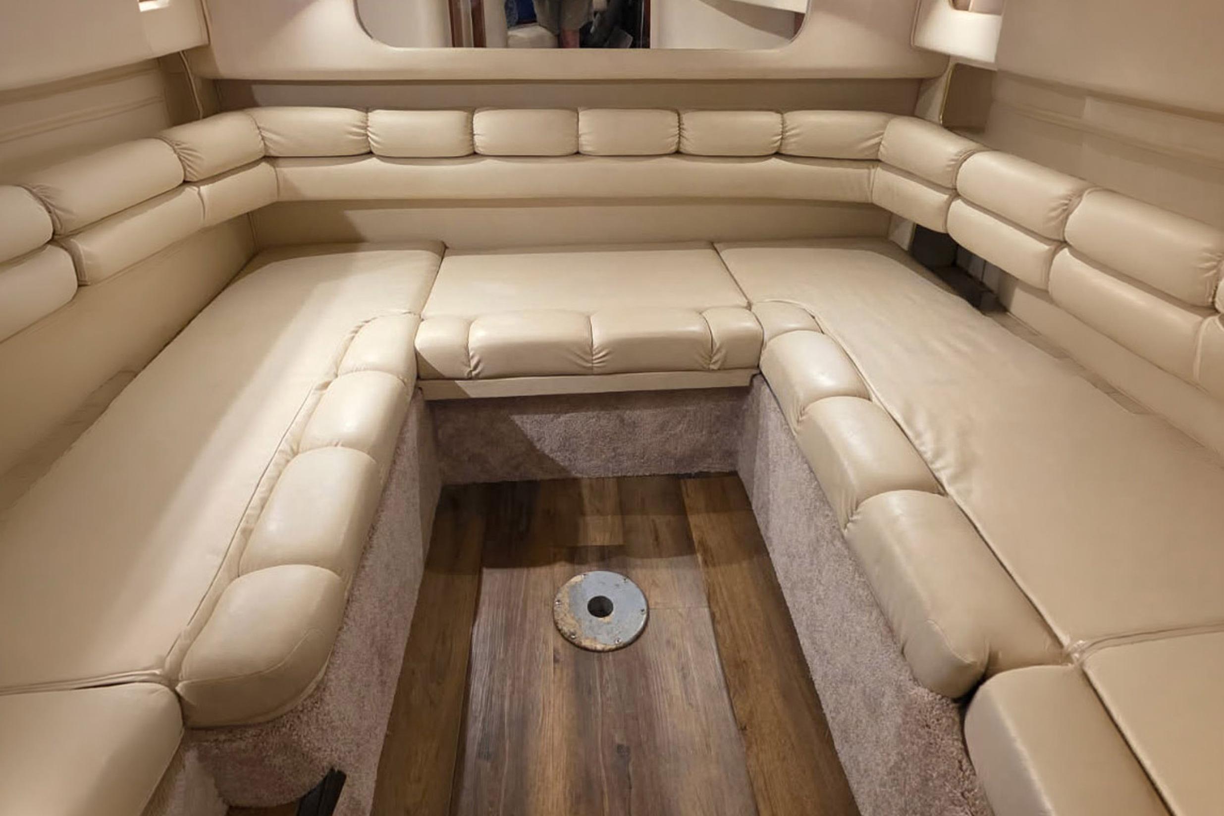 Interior of 1998 Sea Ray Sundancer 400 with beige leather seating and wood flooring.