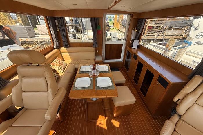 Luxurious interior of 2007 Island Pilot 395 yacht with elegant seating and dining area.