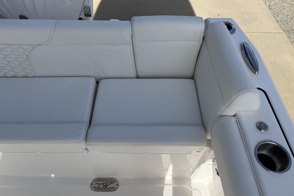 2026 Tidewater 232 LXF boat seating with white upholstery and cup holders.