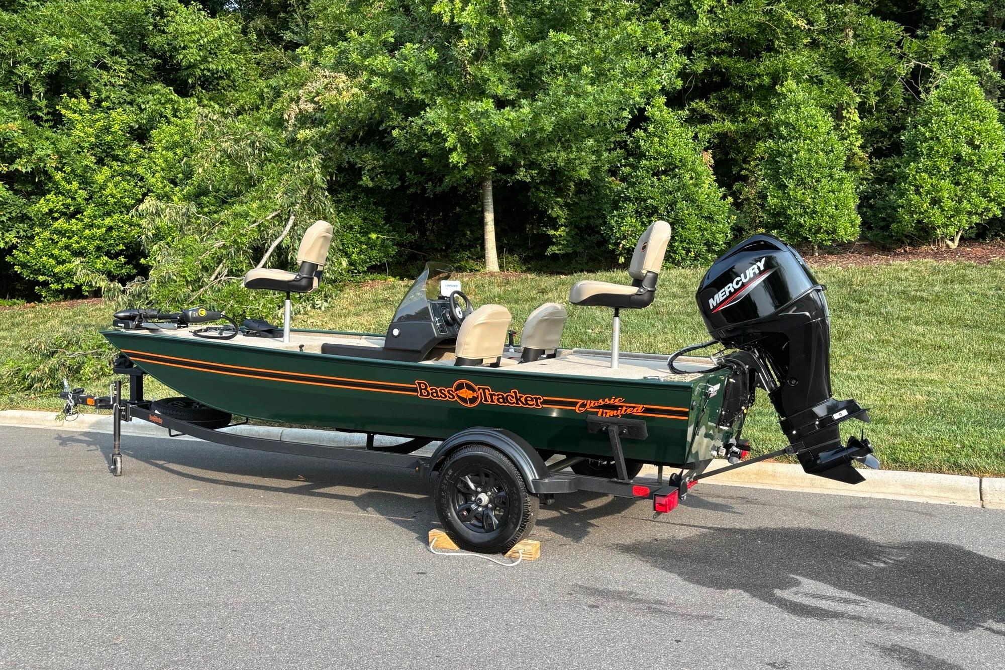 2026 Tracker Bass Tracker Classic Limited boat with Mercury engine, parked outdoors.