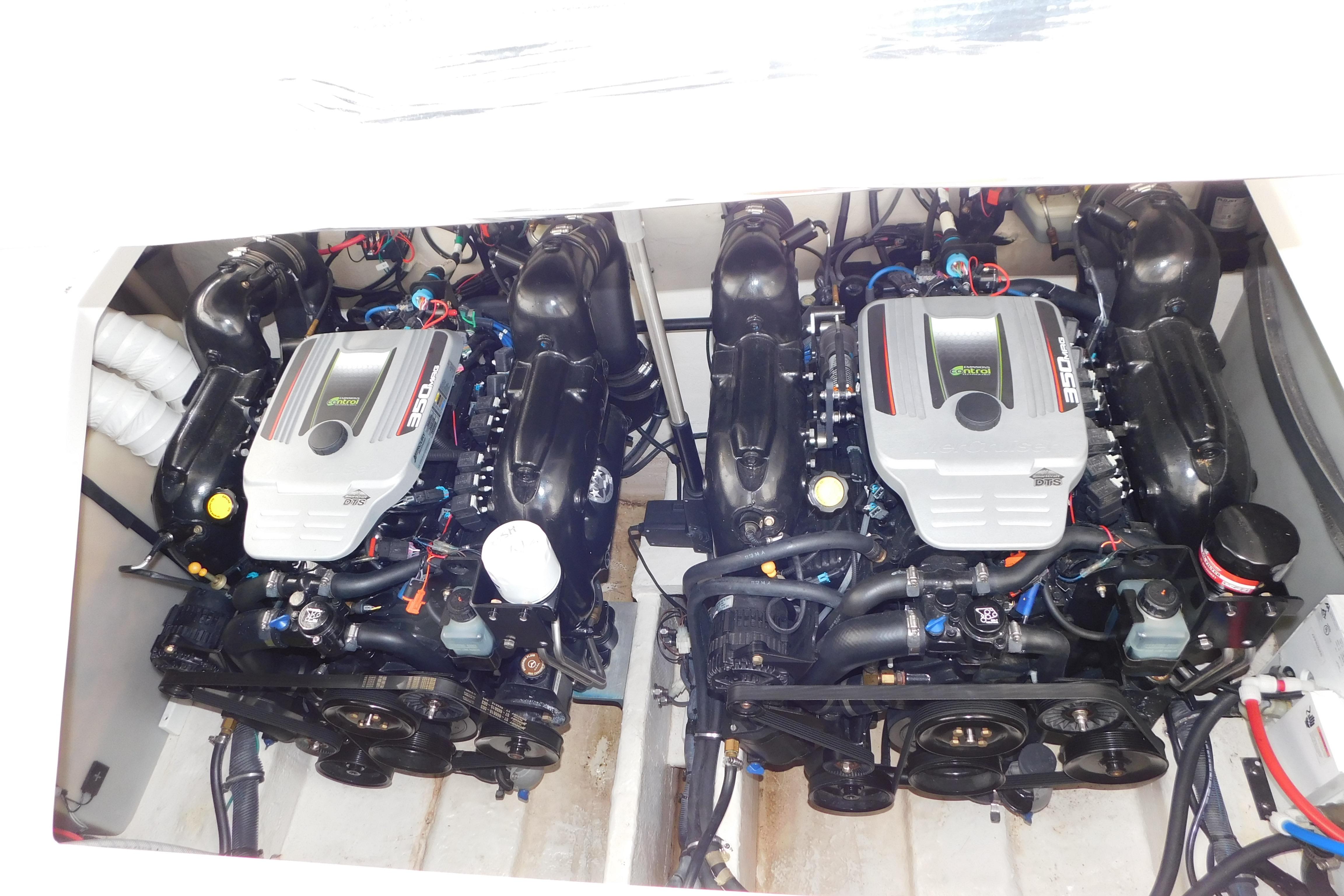 Twin engines in a 2017 Rinker EX 320 boat, showcasing detailed mechanical components.