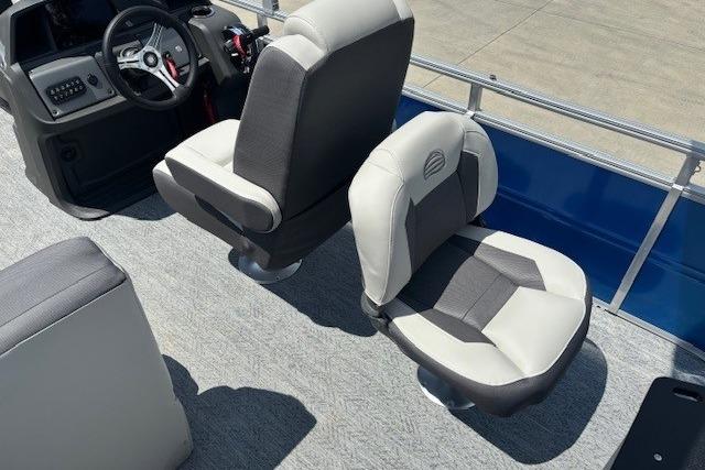 2026 Sun Tracker Fishin' Barge 20 DLX interior with comfortable seating and steering console.