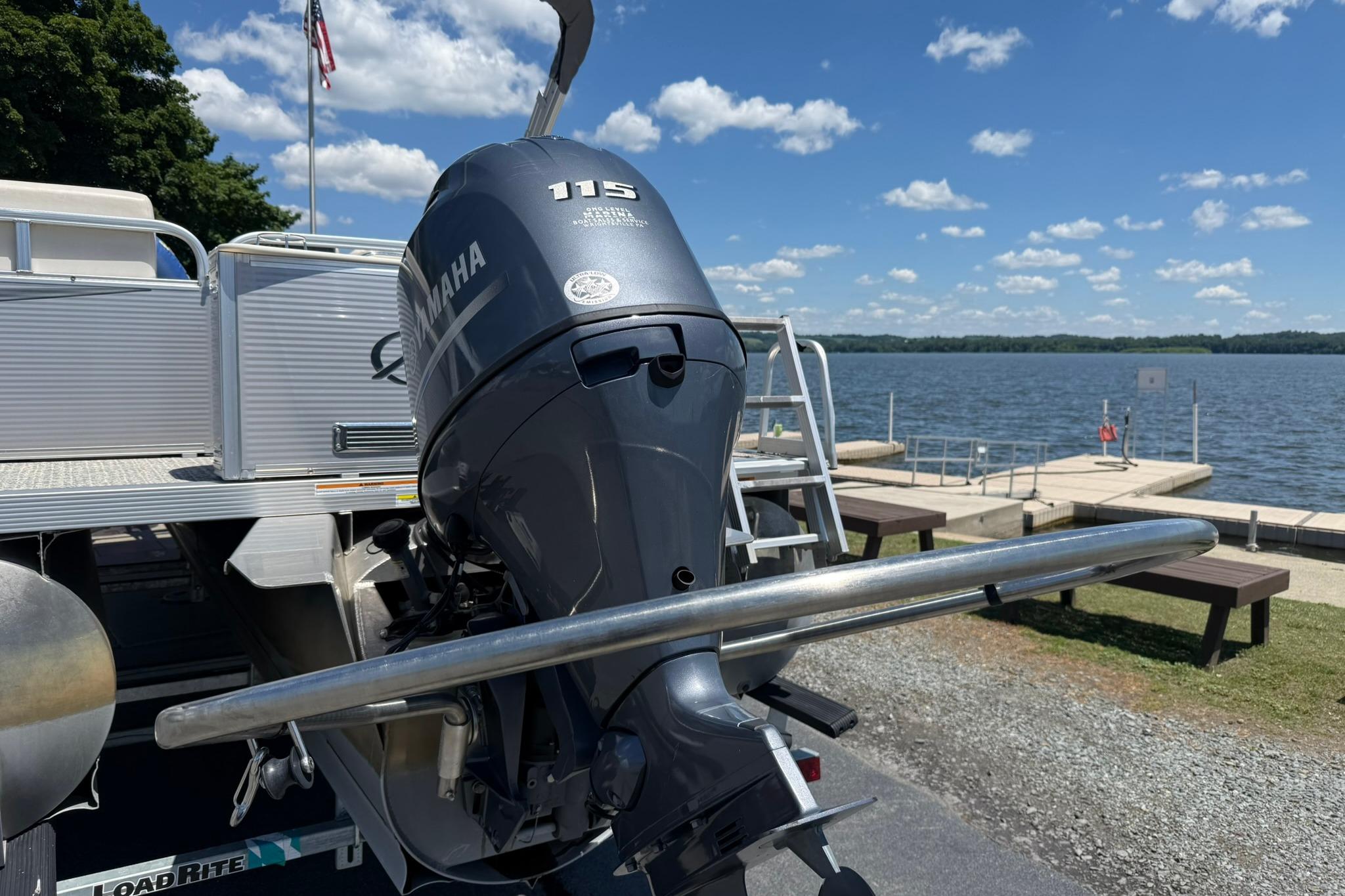 2019 Avalon GS Quad Lounge boat with Yamaha 115 engine by a lakeside dock.