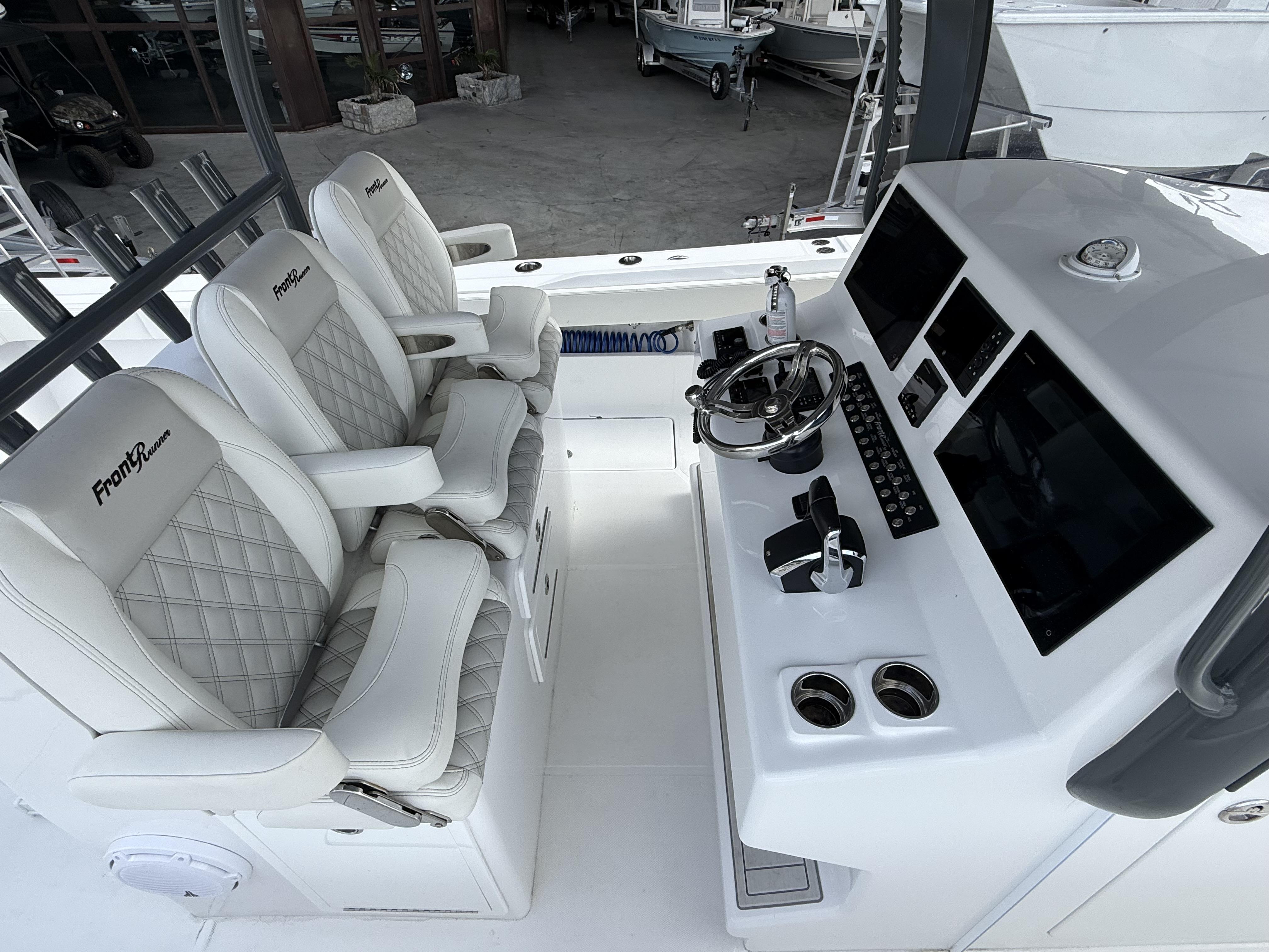 2024 Front Runner 39 CC boat cockpit with luxury seating and advanced control panel.