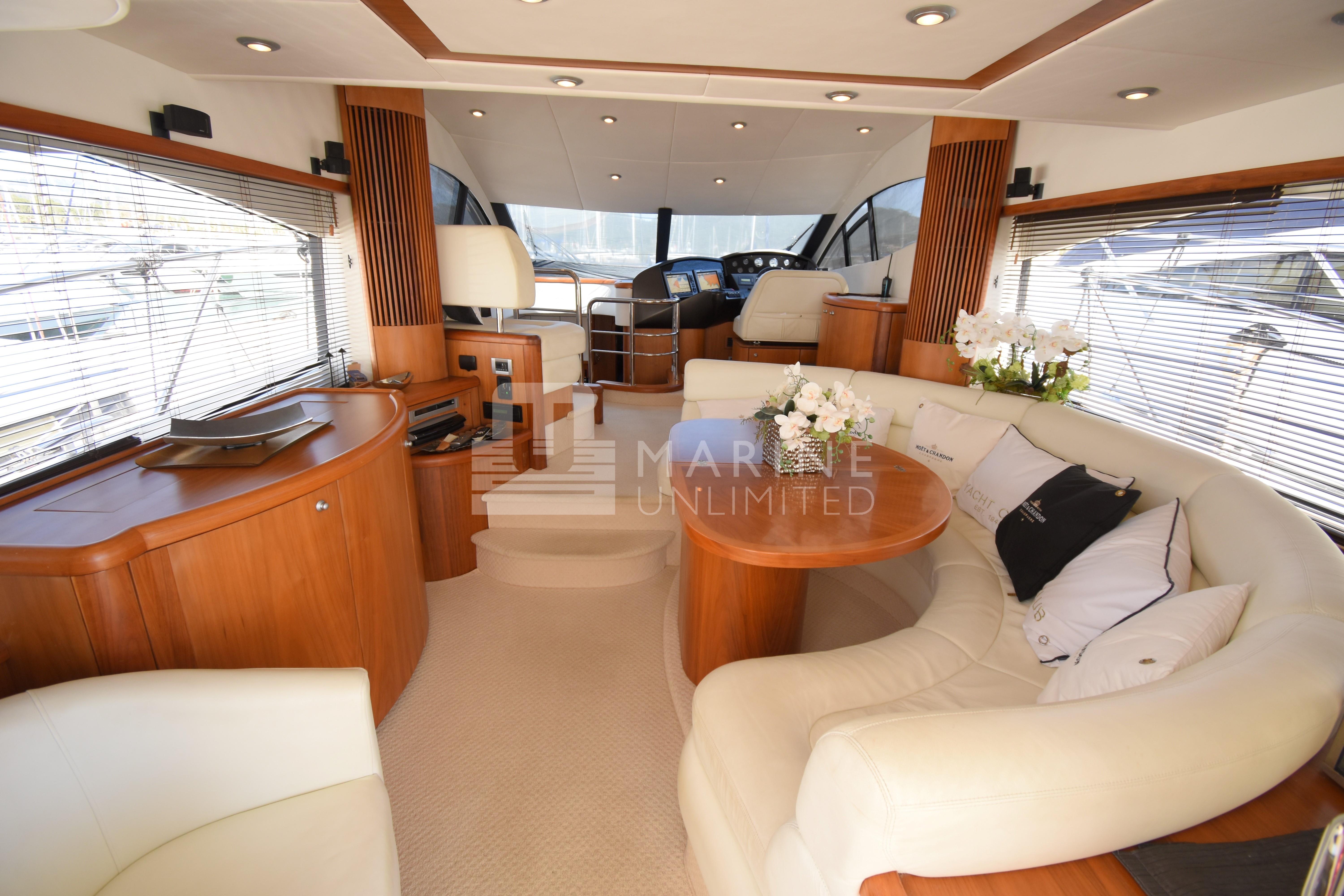 Luxurious interior of 2010 Sunseeker Manhattan 52 yacht with elegant seating and wooden finishes.