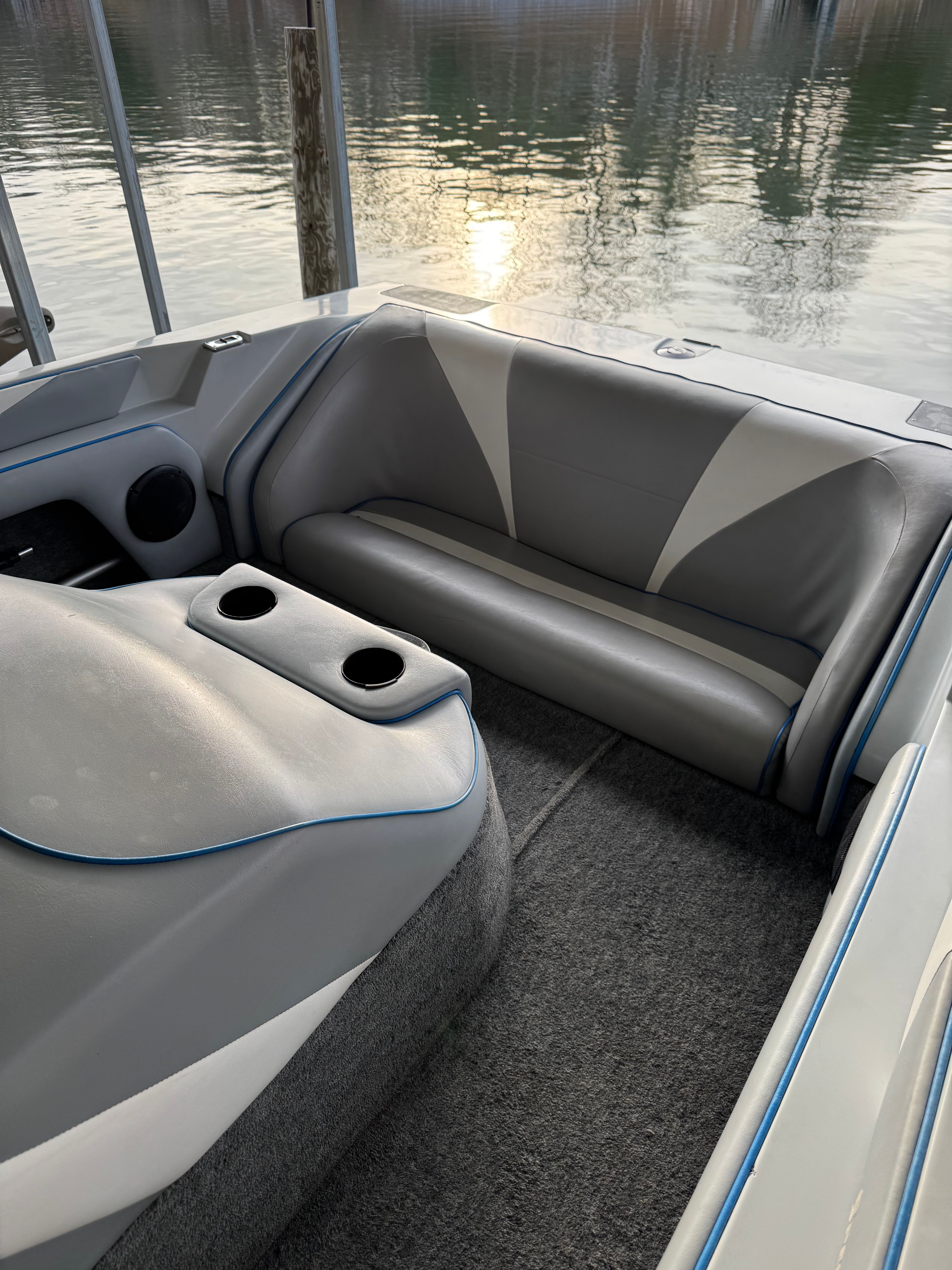 Interior of a 1992 Ski Brendella Spectrum boat by the water.