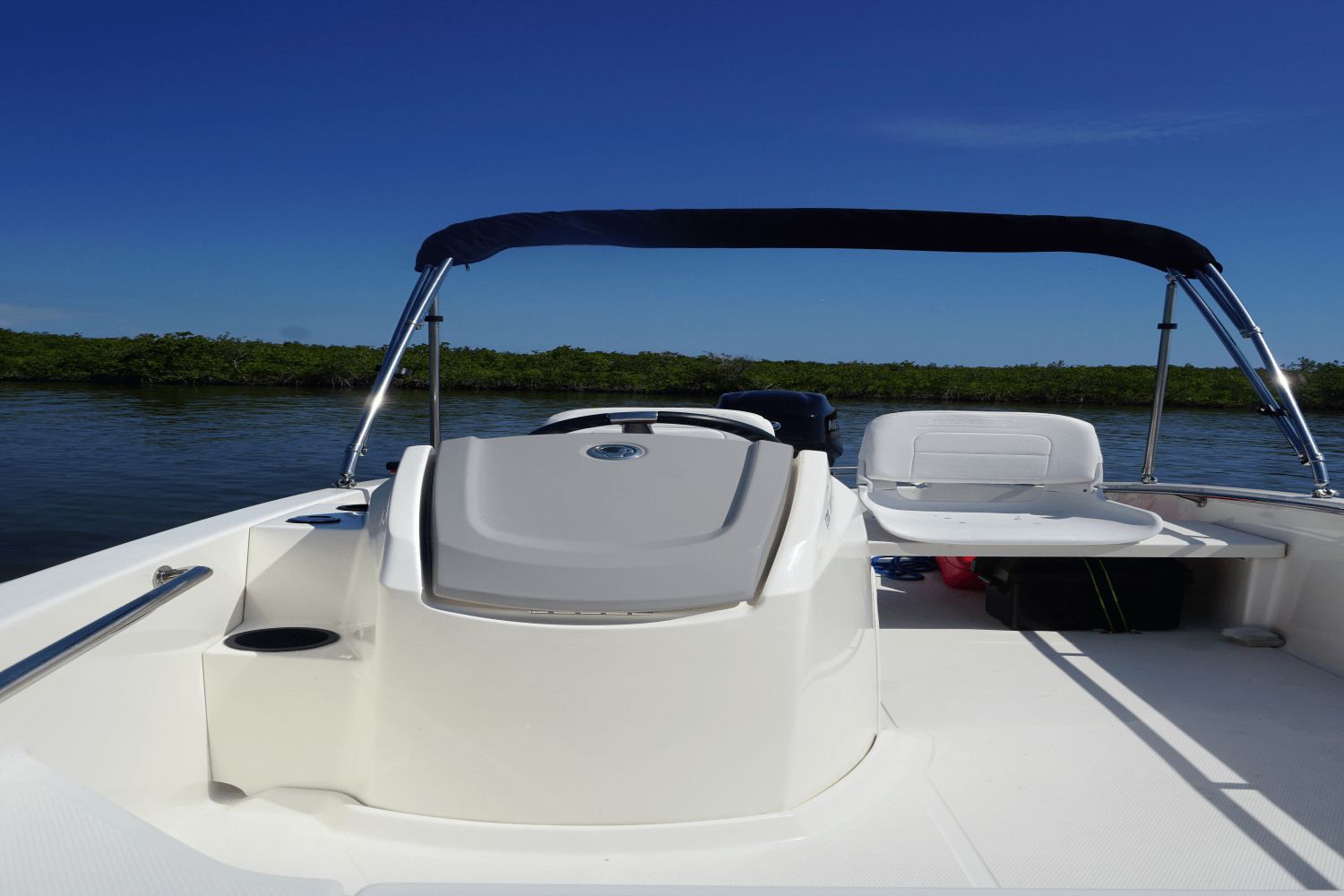 Boston Whaler 130 Super Sport 2026 on calm water with clear skies.