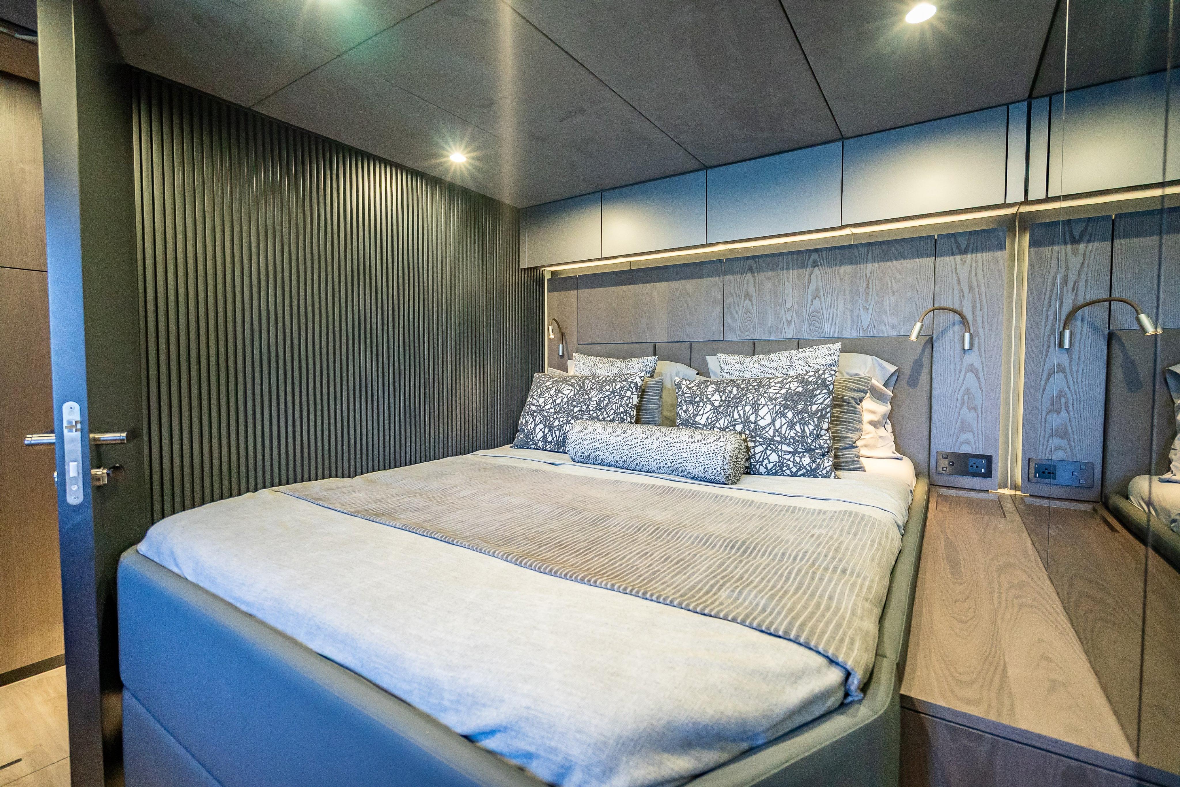 Luxurious bedroom interior on 2026 Sunreef 60 Power yacht, featuring modern design and elegant bedding.